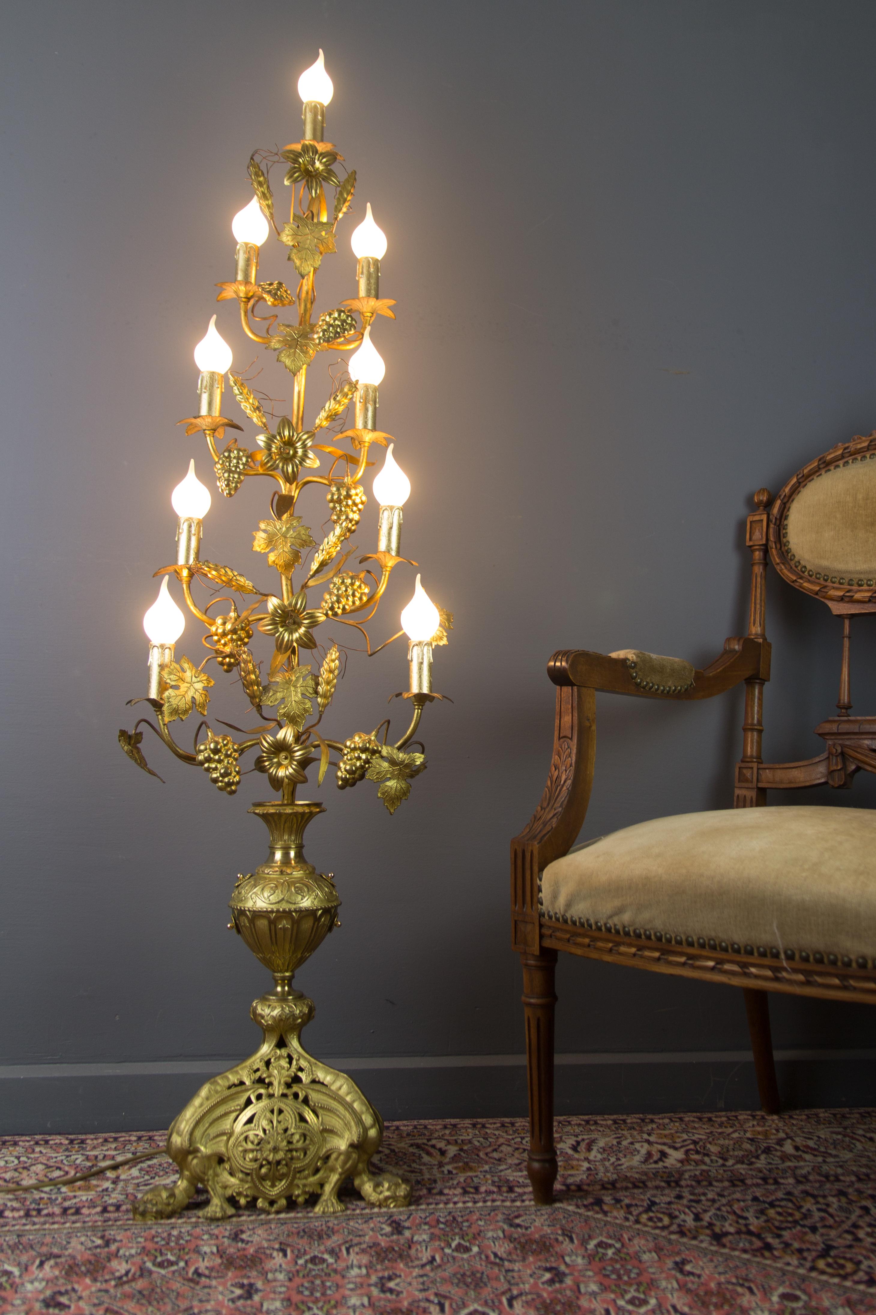 Large and beautiful electrified candelabra to floor lamp, made of gilt bronze and brass, decorated with brass lily flowers and leaves, ears of wheat, vines, and vine leaves. Impressive and ornate bronze base. Nine arms, each with a socket for an
