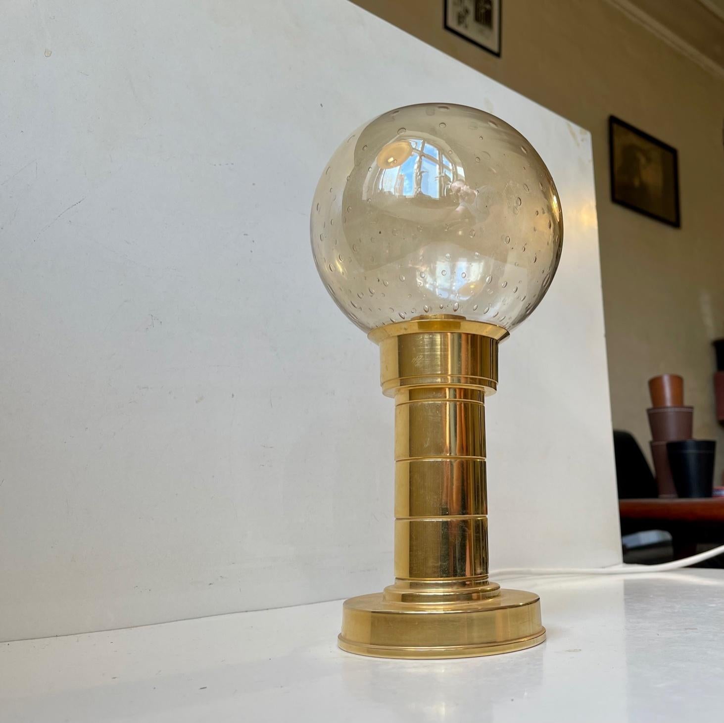 Gold plated brass base designed and manufactured by Föhl in Germany circa 1970-75. Originally it came as a candleholder b ut since then it has been altered to a Table Lamp featuring a hand-blown glass shade injected with air-bubbles. The style of
