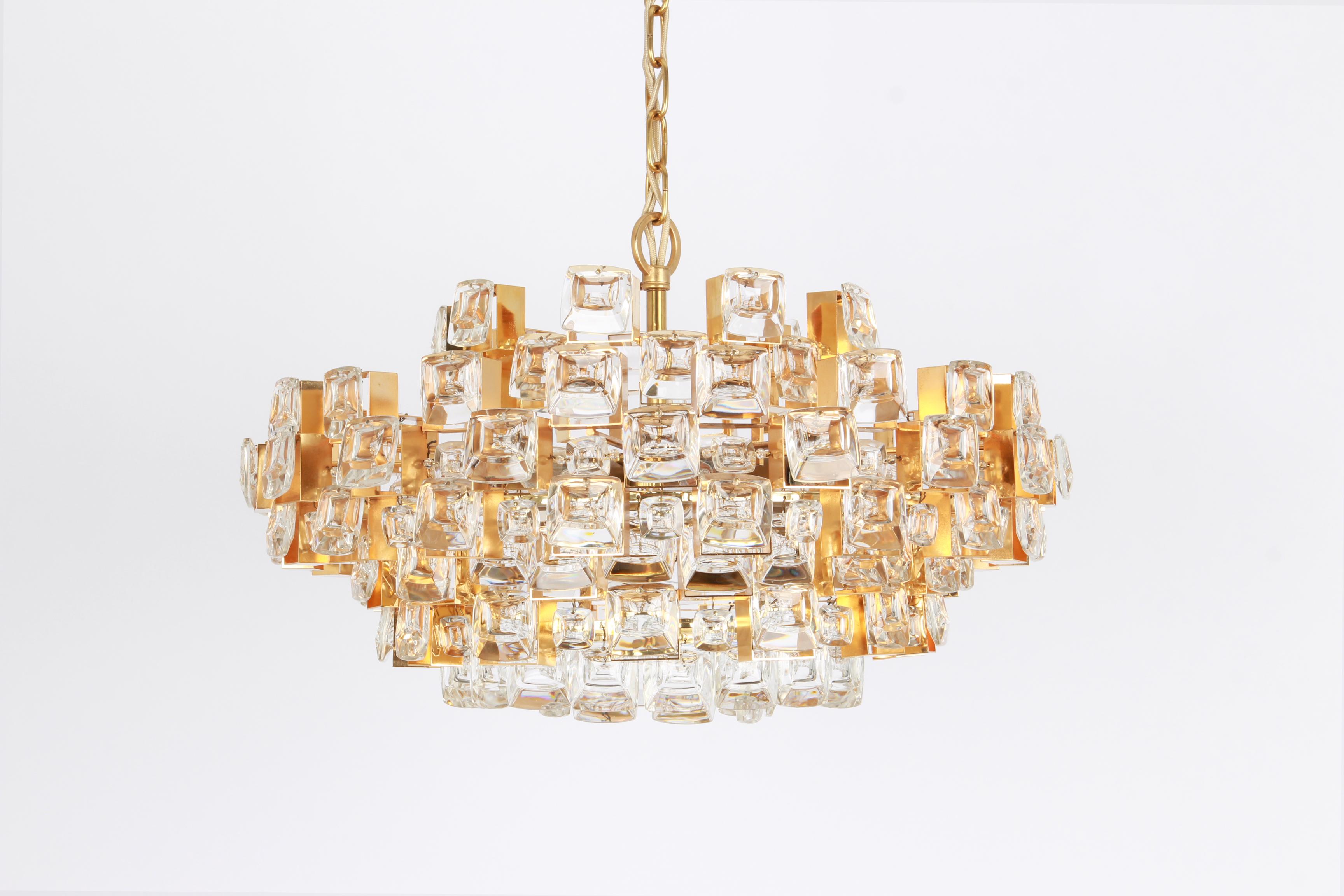 A wonderful and high quality gilded chandelier or pendant light fixture by Palwa -Design Sciolari, Germany, 1970s.

It is made of a 24 carat gold-plated brass frame decorated with individual 
