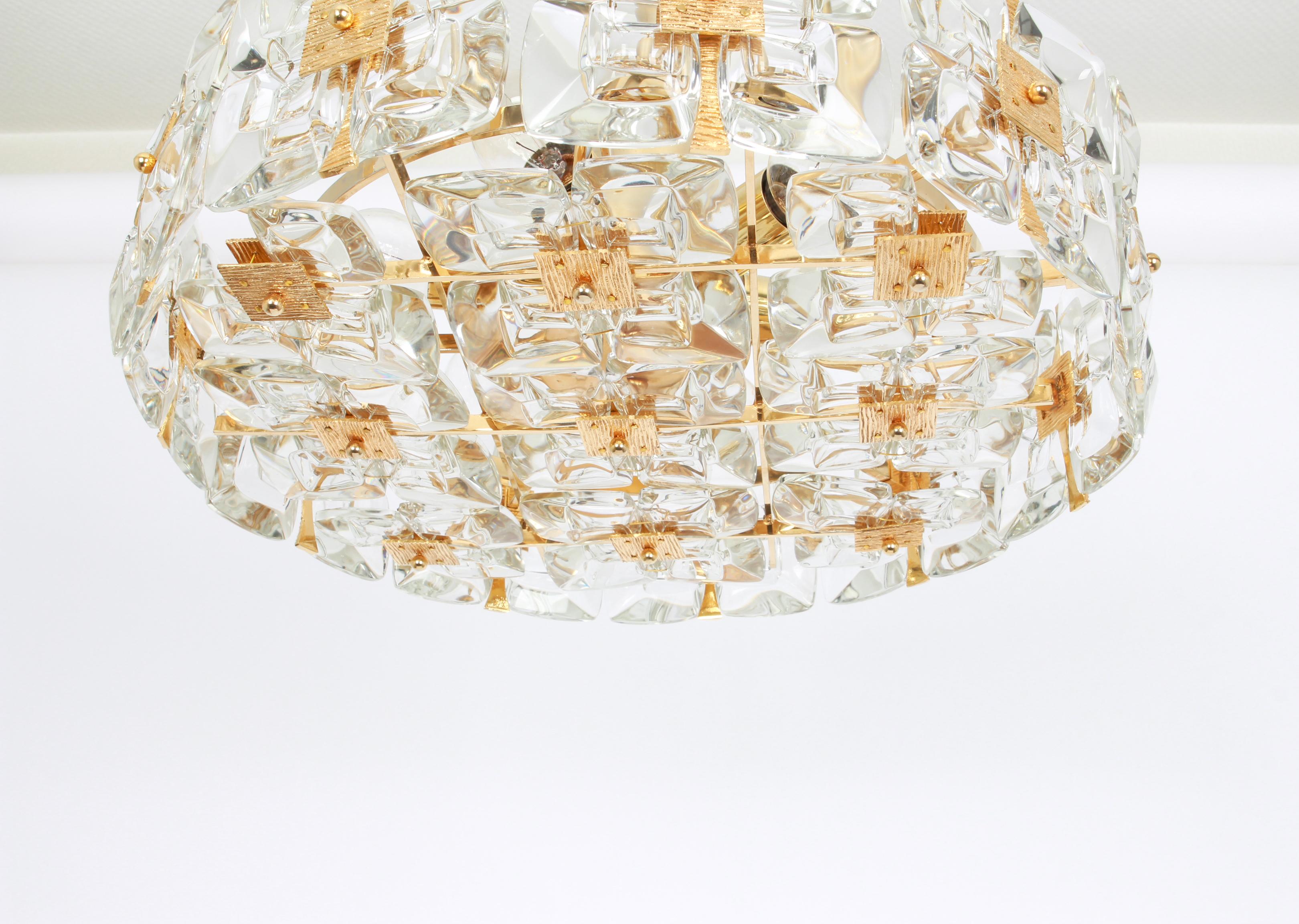 A wonderful and high quality gilded chandelier or pendant light fixture by Palwa -Design Sciolari, Germany, 1970s.

It is made of a 24 carat gold-plated brass frame decorated with individual 
