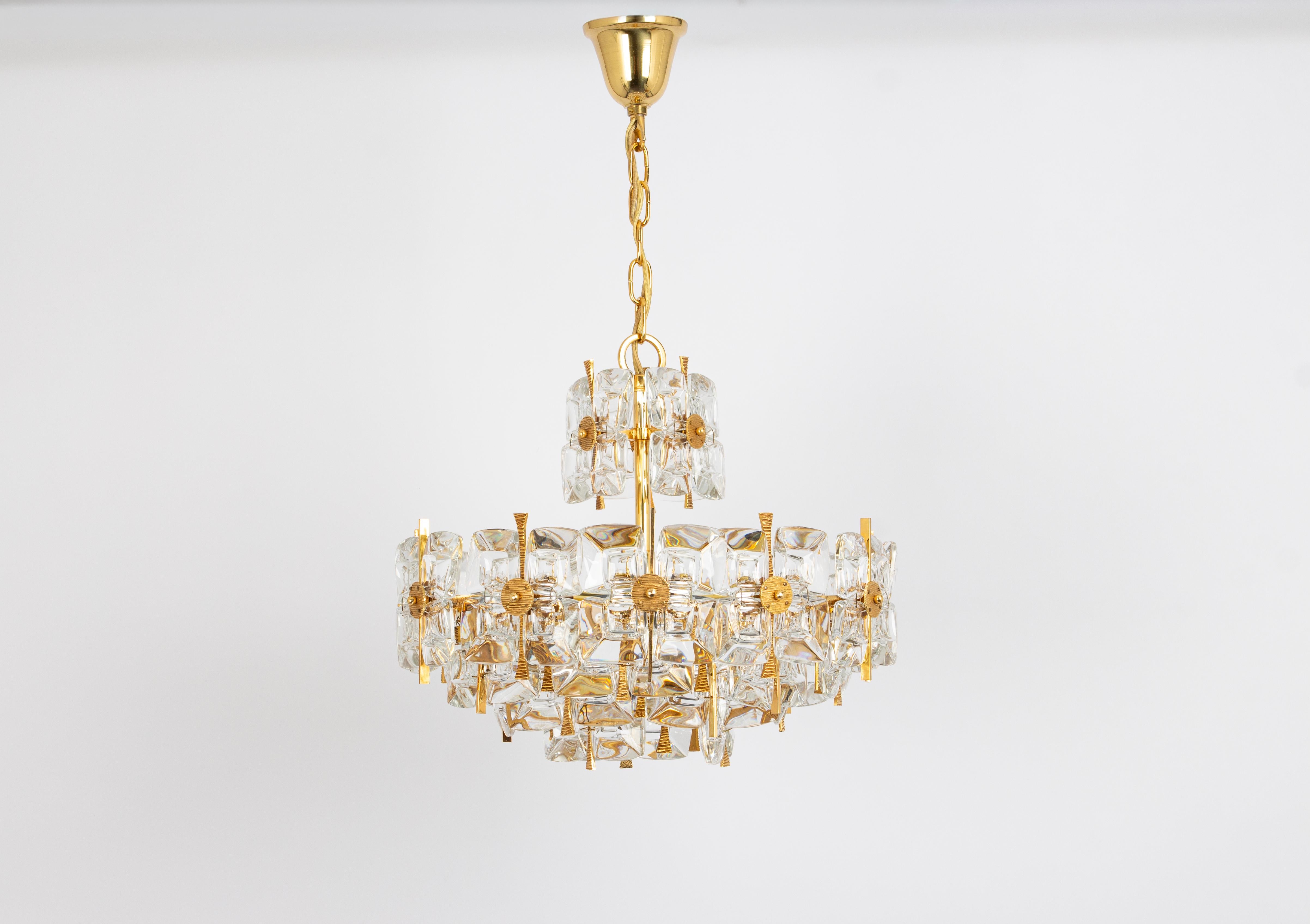 A wonderful and high quality gilded chandelier or pendant light fixture by Palwa -Design Sciolari, Germany, 1970s.
It is made of a 24 carat gold-plated brass frame decorated with individual 