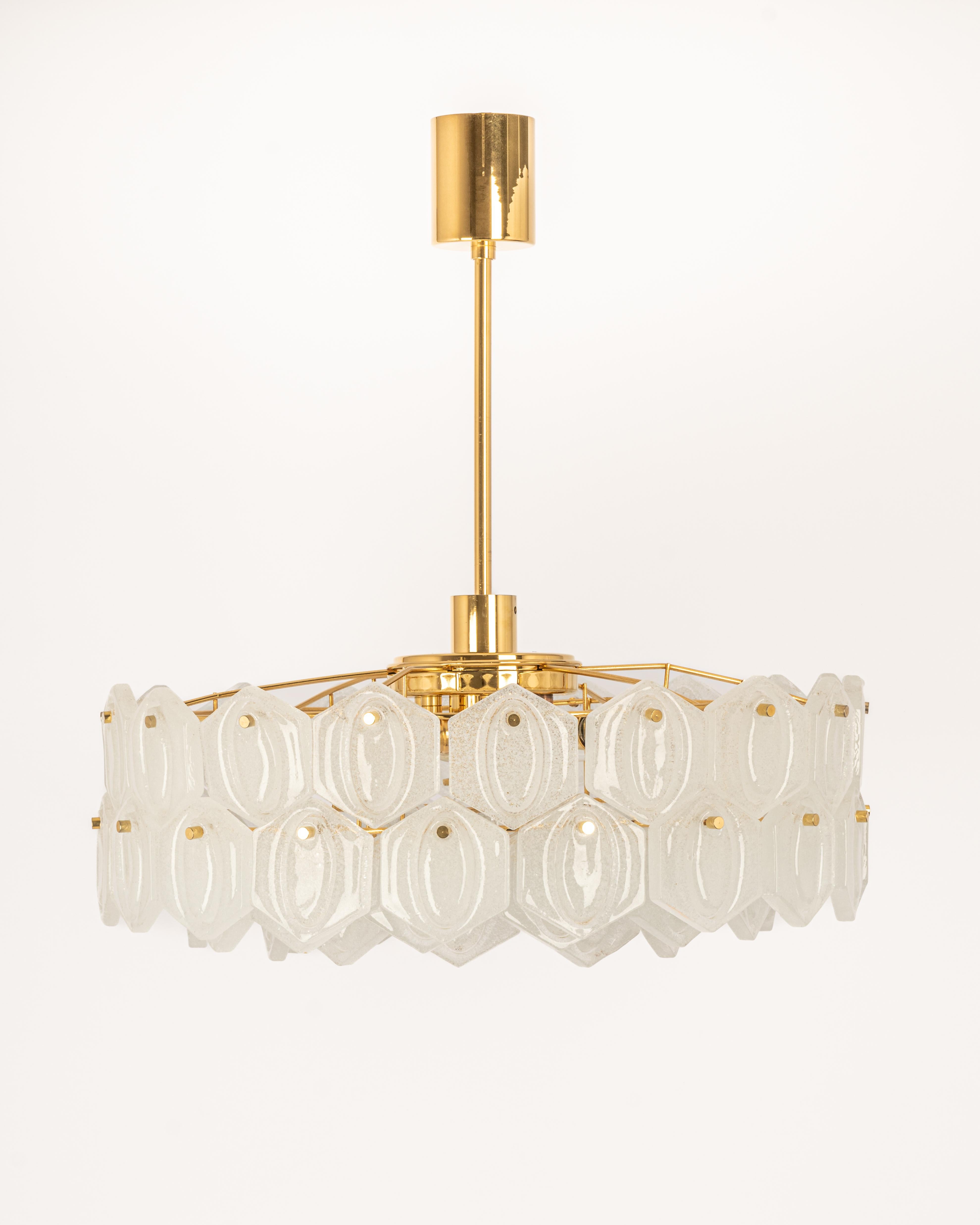 A stunning four-tier chandelier by Kinkeldey, Germany, manufactured in circa 1970-1979. A handmade and high quality piece. The chandelier features a 24-karat gold-plated four-tier structure with lots of facetted Murano glass elements.

High