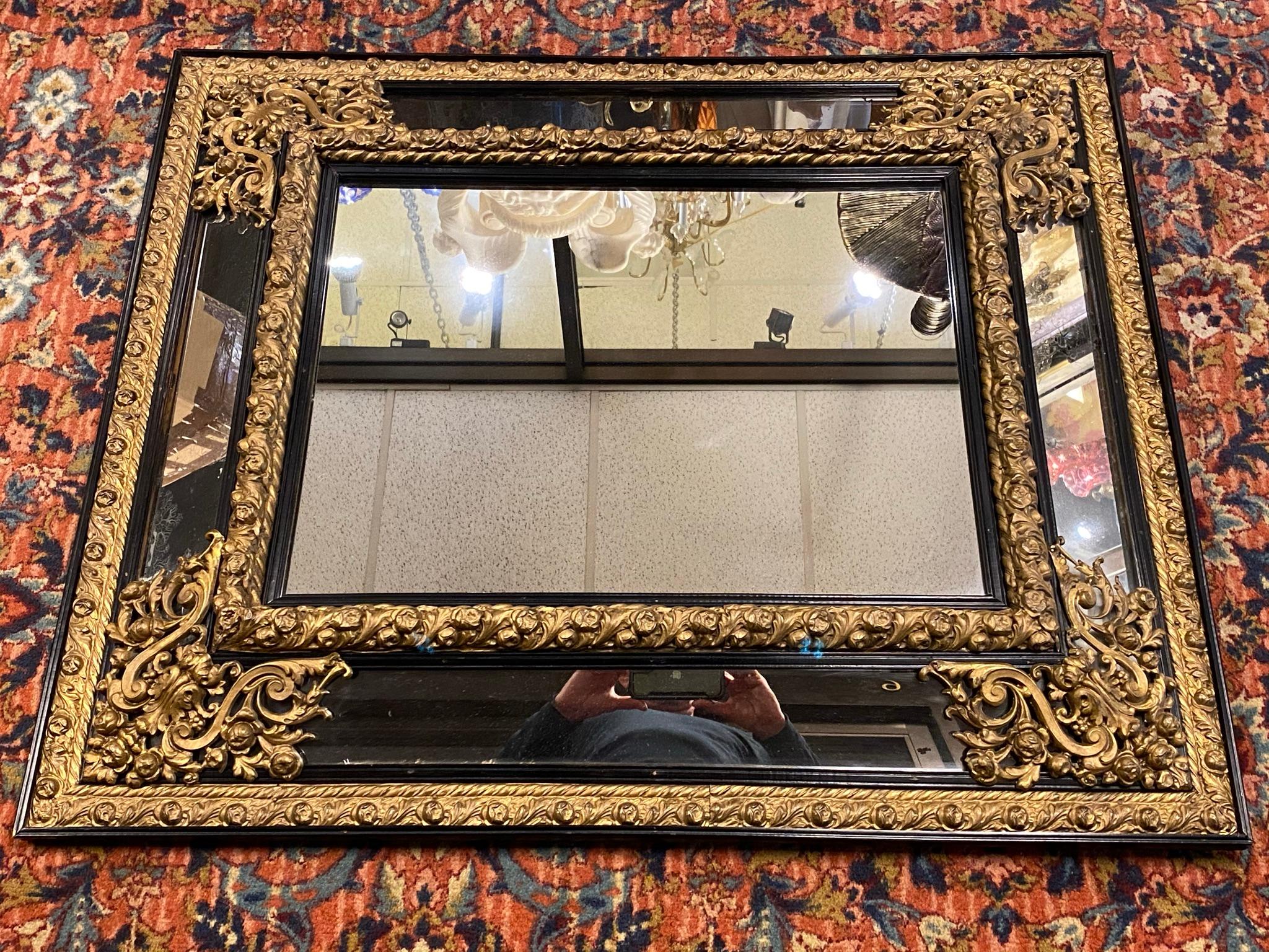 French 19 century gilt embossed brass and ebonized wooden over mantel Mirror.