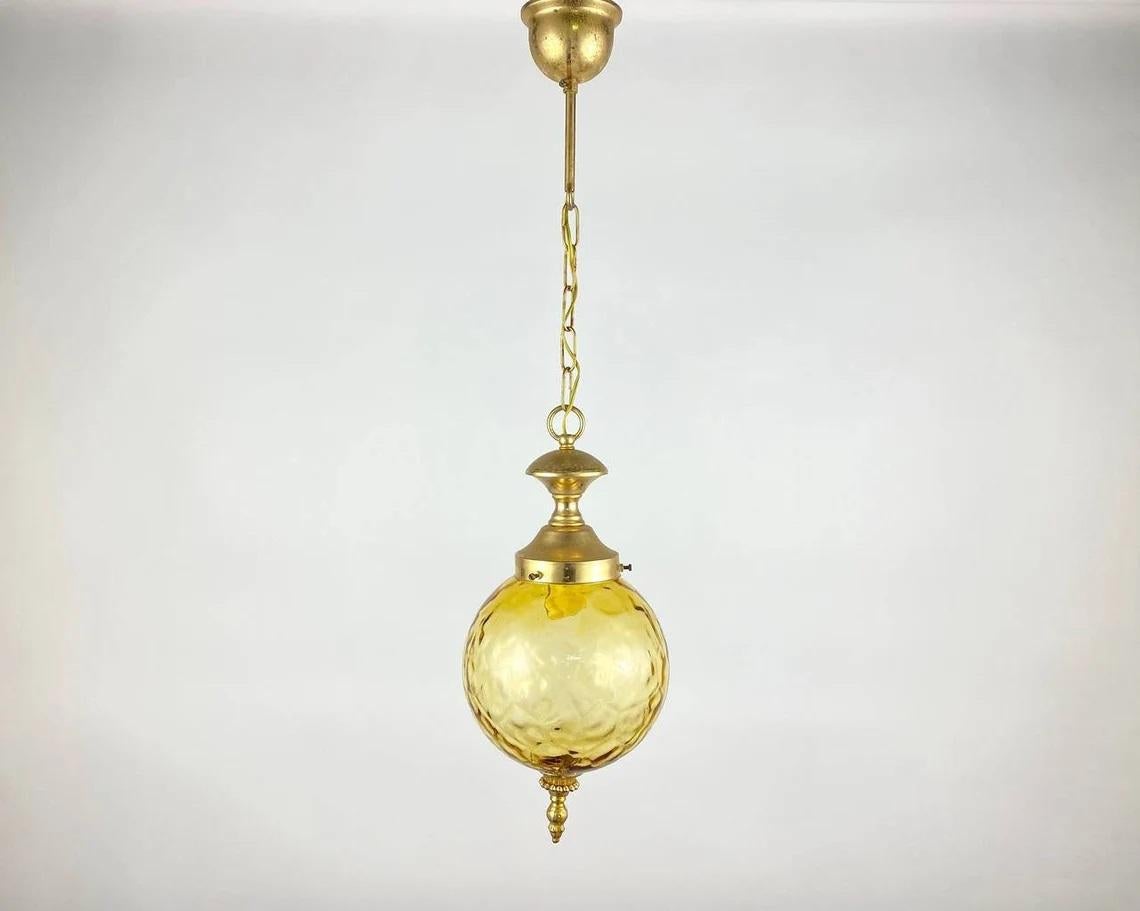 Vintage textured glass and gilded brass ceiling chandelier or lantern.

Beautifully detailed, antique hanging lamp, lantern. The textured glass plafond is set in a gold-plated brass rim. The gilded parts are beautifully decorated and the glass