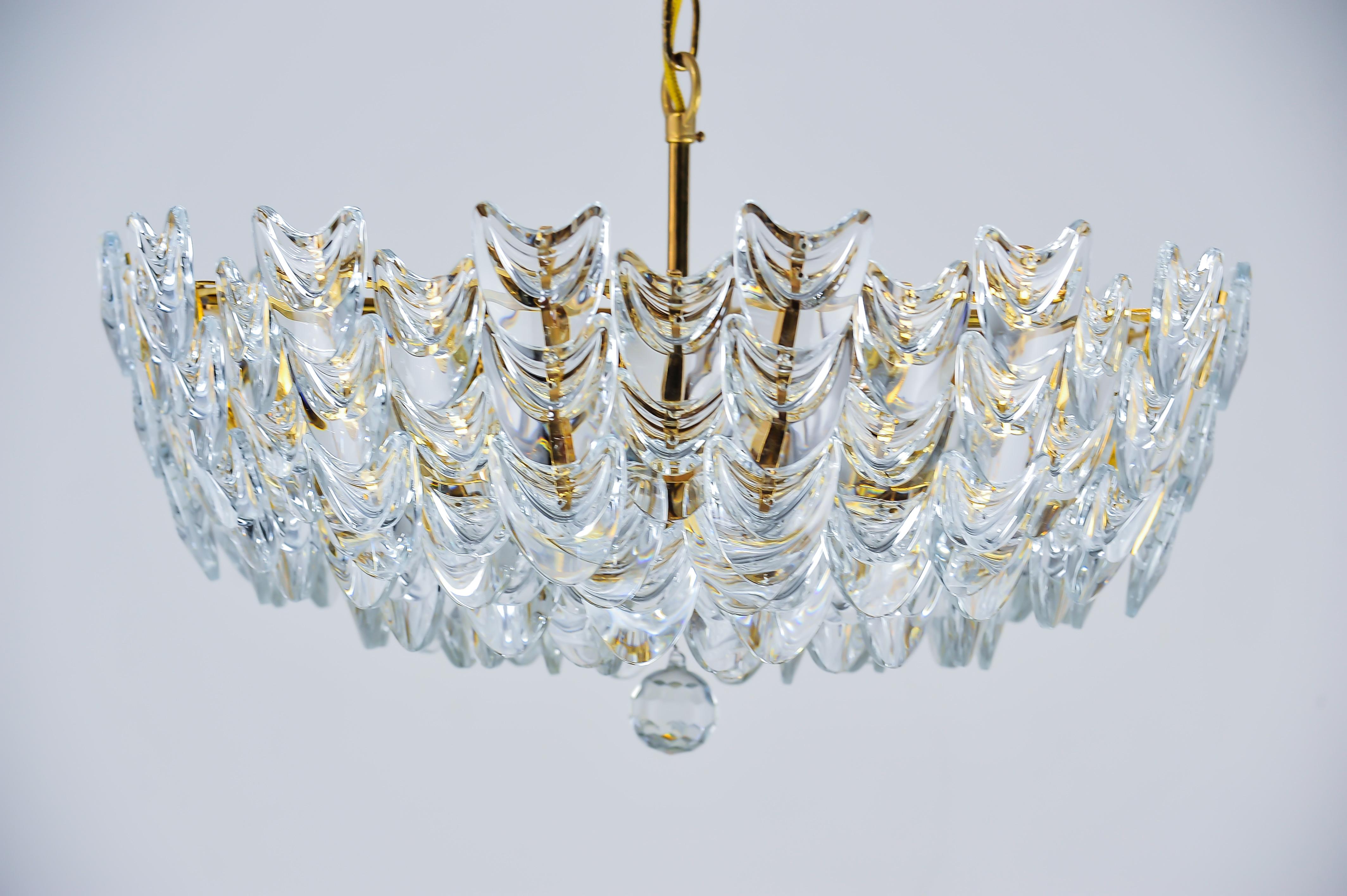 A gilt brass chandelier with glass. German, circa 1960s.
Original condition.