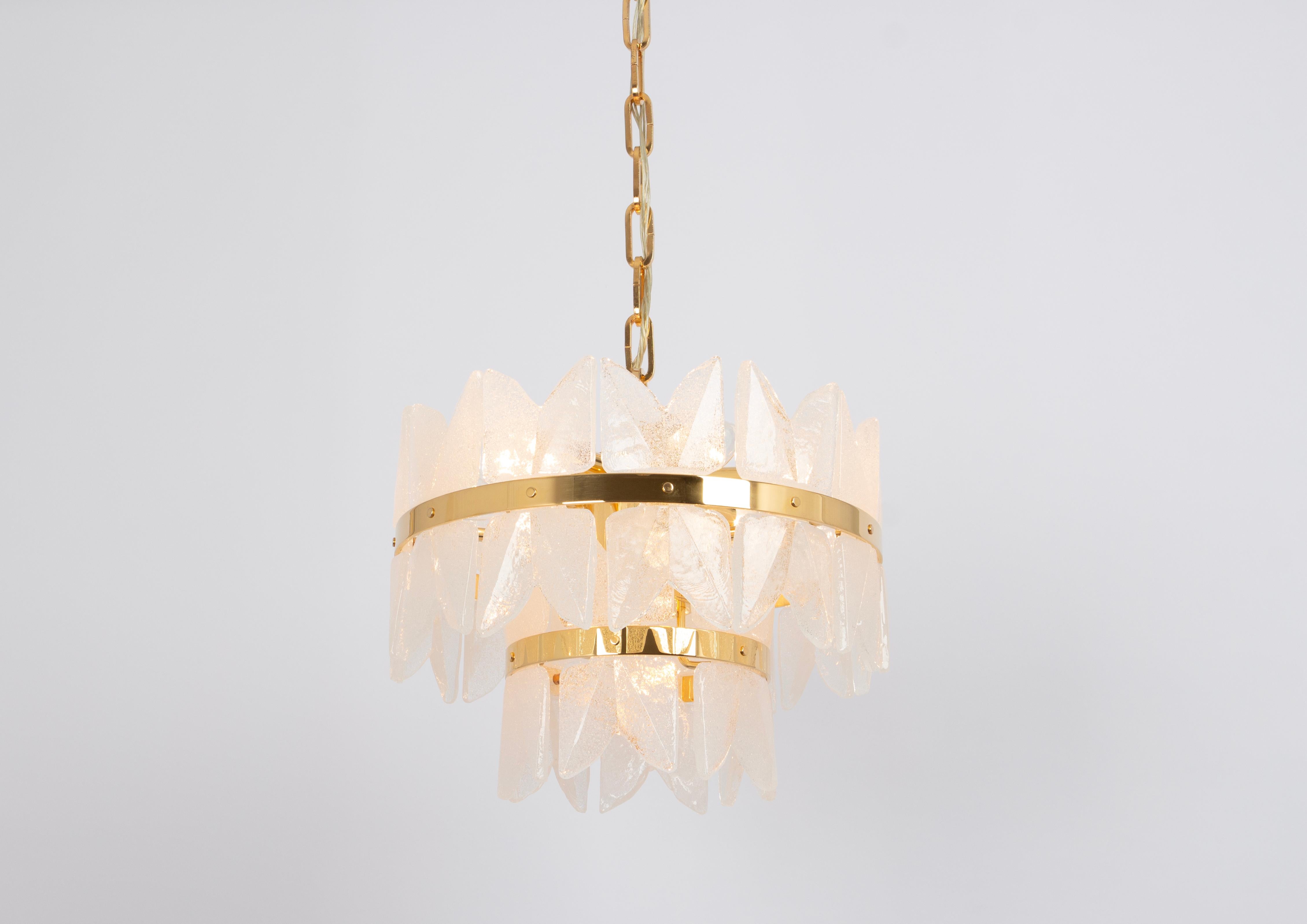 A wonderful gilt brass light fixture made by Kalmar (Series: Corina), Austria, manufactured, circa 1970-1979.
Three tiers structure gathering many structured polished crystal glass pieces, beautifully refracting the light very heavy quality.


High