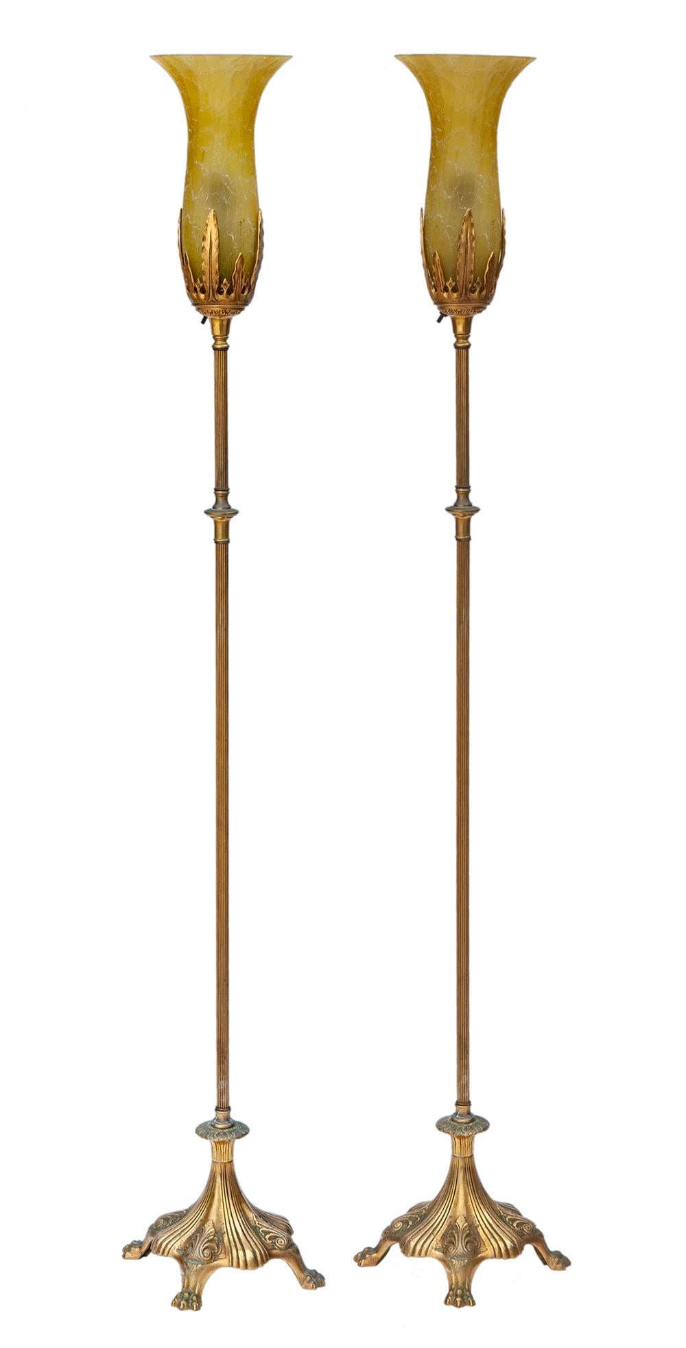 A pair of elegant 1920's brass, cast iron & bronze floor lamps, a pair.
Original period art glass shades are included.
One of the shades has been professionally repaired.
Recently re-wired, with silk cords.
