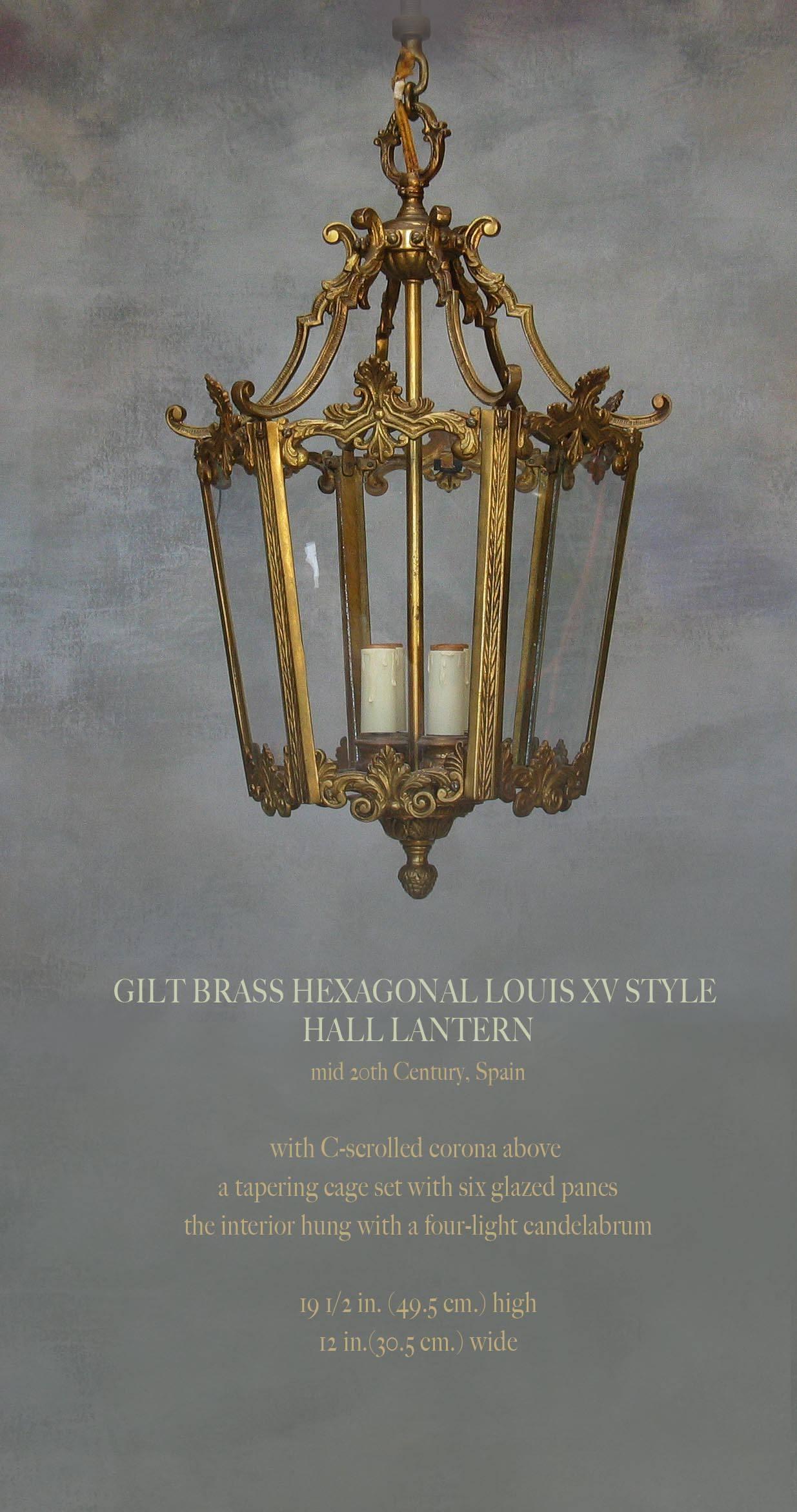 Gilt brass hexagonal Louis XV style hall lantern, mid-20th century, Spain, Hall Lantern with a fancy C-scrolled corona above a tapering cage set with six glazed panes the interior hung with a four-light candelabrum. The hall lantern measures 19