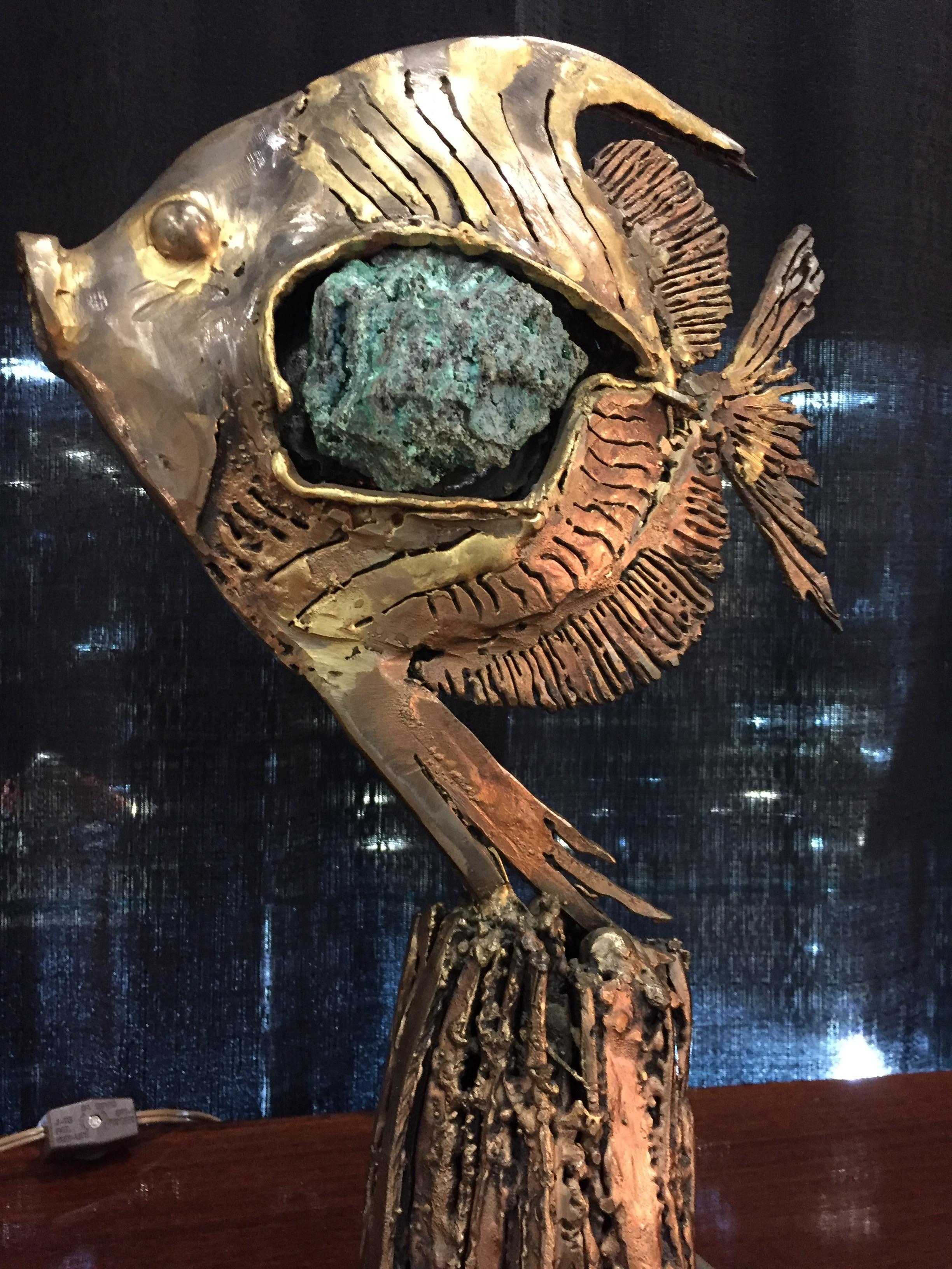 Sculpture gilt brass and turquoise color stone included in the center of the fish.
 