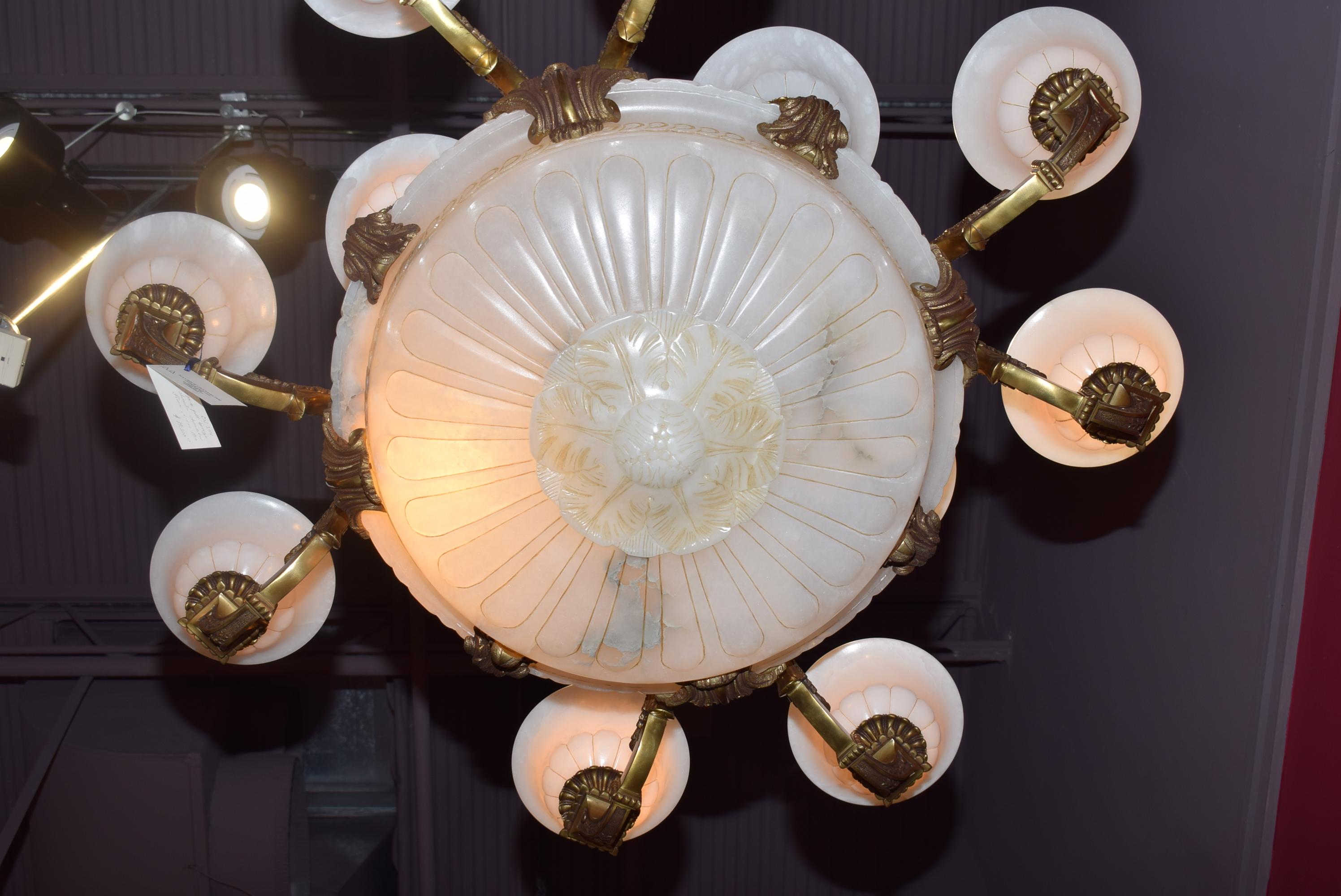A magnificent gilt bronze and alabaster chandelier with hand carved alabaster dome and shades. Please notice the intricate carving of the dome.
France, circa 1910. 20-light (16 inside shades; 4 inside dome)
Dimensions: Height 45