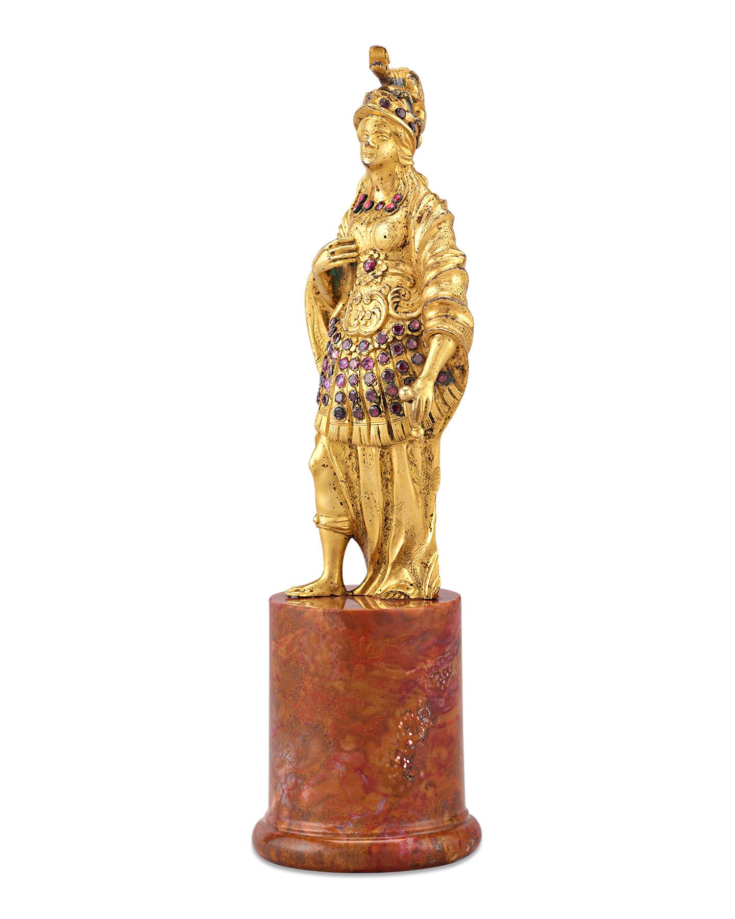 This exceptionally rare 17th century statuette captures the regal figure of the Roman goddess Minerva. The legendary goddess of war is crafted from highly detailed gilt bronze, with her armor encrusted with deep purple amethysts and other semi