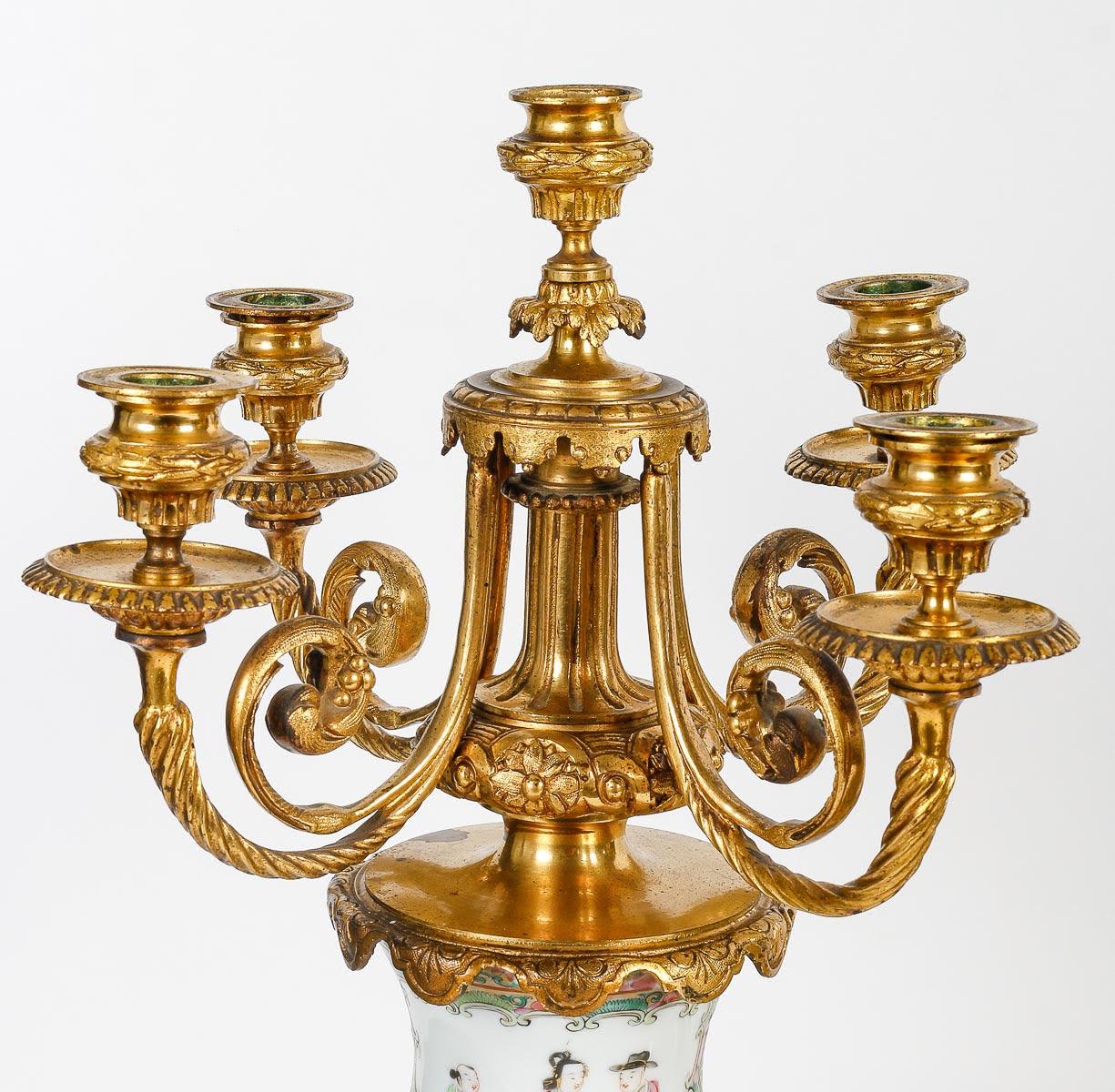 Gilt Bronze and Canton Porcelain Mantel Set, China.

An important gilt bronze and Canton porcelain mantel set, Napoleon III period, 19th century, China.
Candelabra: h: 54.5cm, d: 26cm
Bowl: h: 31cm, w: 48cm, d: 26cm
