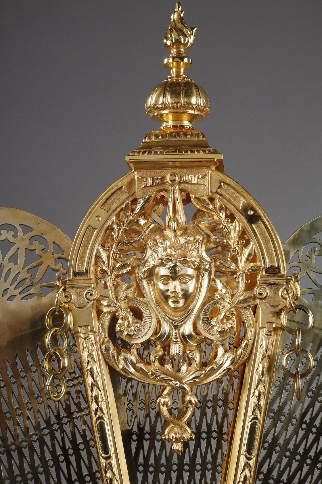 Gilt bronze and chased fan-shaped fire screen with female face decoration 4