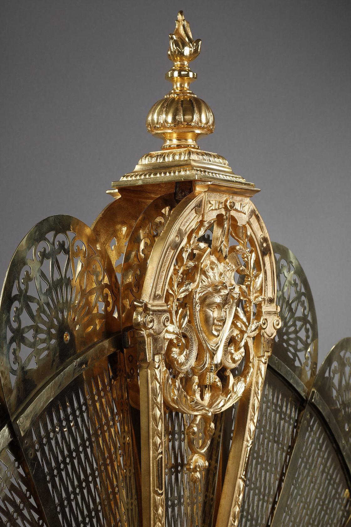 French Gilt bronze and chased fan-shaped fire screen with female face decoration