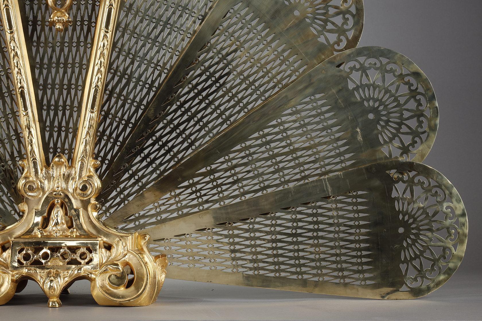 Brass Gilt bronze and chased fan-shaped fire screen with female face decoration