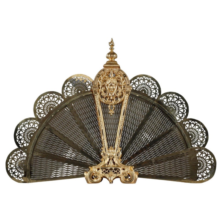 Gilt bronze and chased fanshaped fire screen with female face