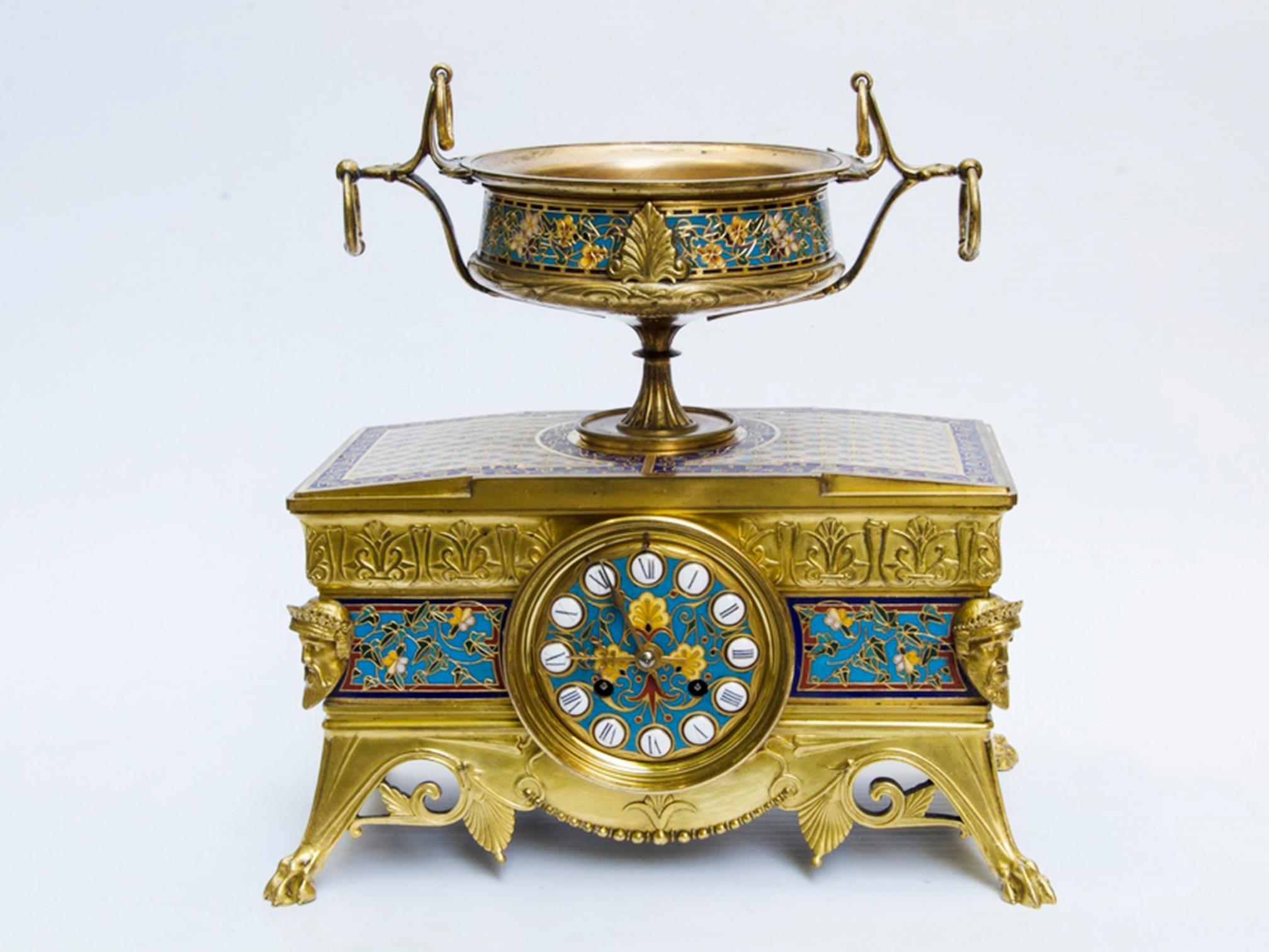 Garniture set by Barbedienne and Louis-constant Sévin
Clock surmounted by a cup and two candlesticks.
Gilt bronze and cloisonné enamels.

Napoleon III period, 19th century.
Very good condition, very good quality of gilding, entirely