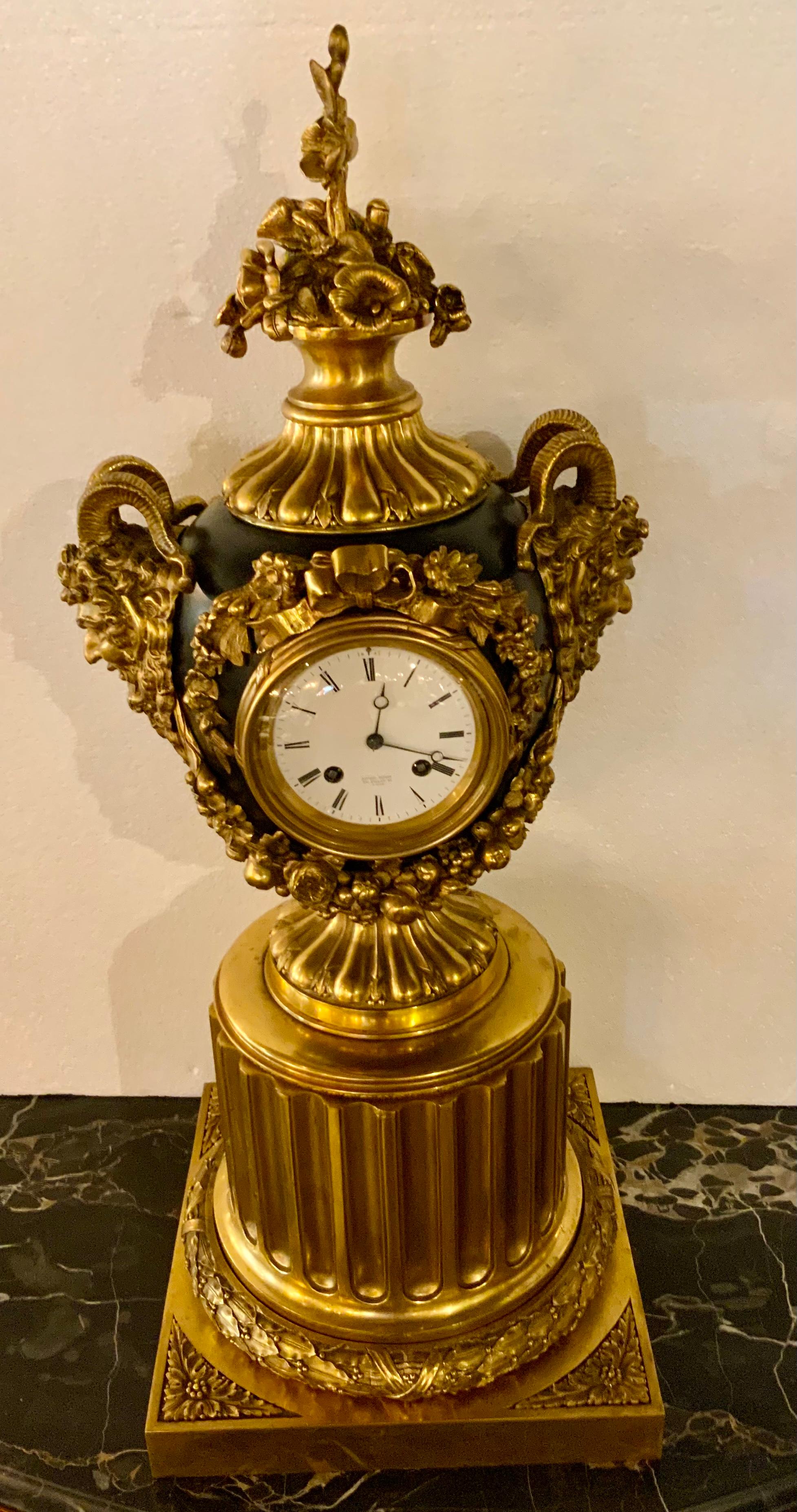 This clock is very dramatic in appearance with bright gold gilt ornamentation 
With designs in floral and foliate elements. Gilt masques decorate the
The sides. The clock is in good working condition and has the original 
Key and pendulum. It