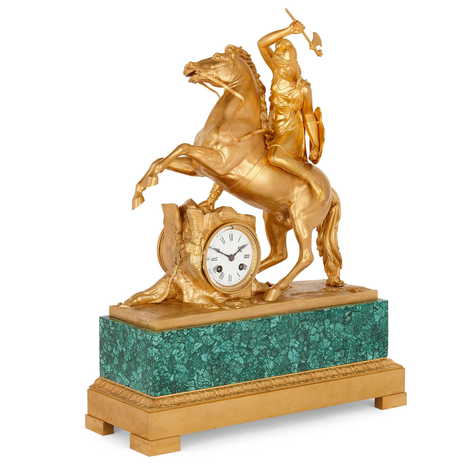This superb gilt bronze and malachite mantel clock was created during the Charles X period, with the malachite veneer being a later addition. The clock is defined by a large sculptural group, created from gilt bronze, which portrays a classical