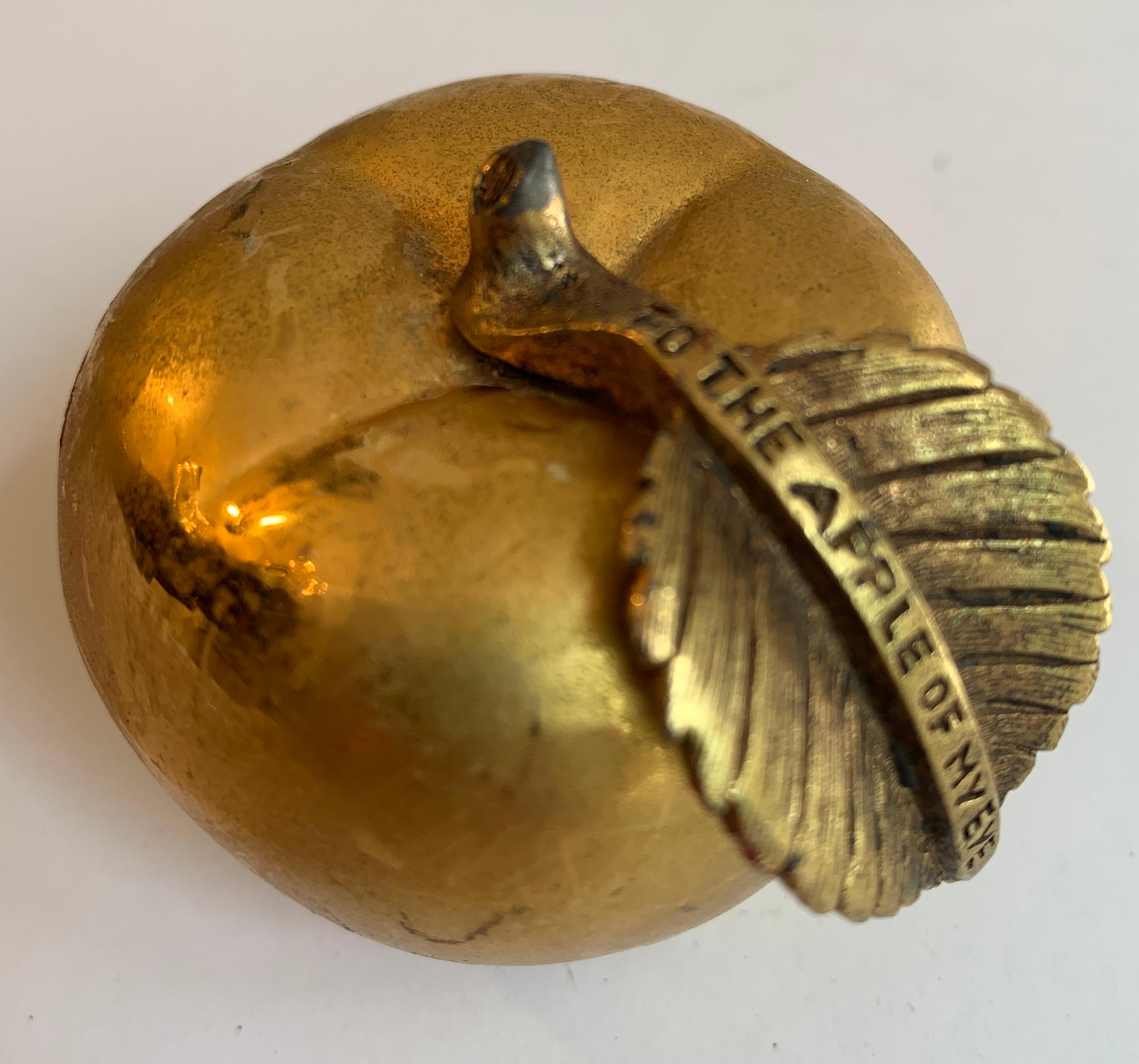 Gilt bronze apple paper weight that reads, 