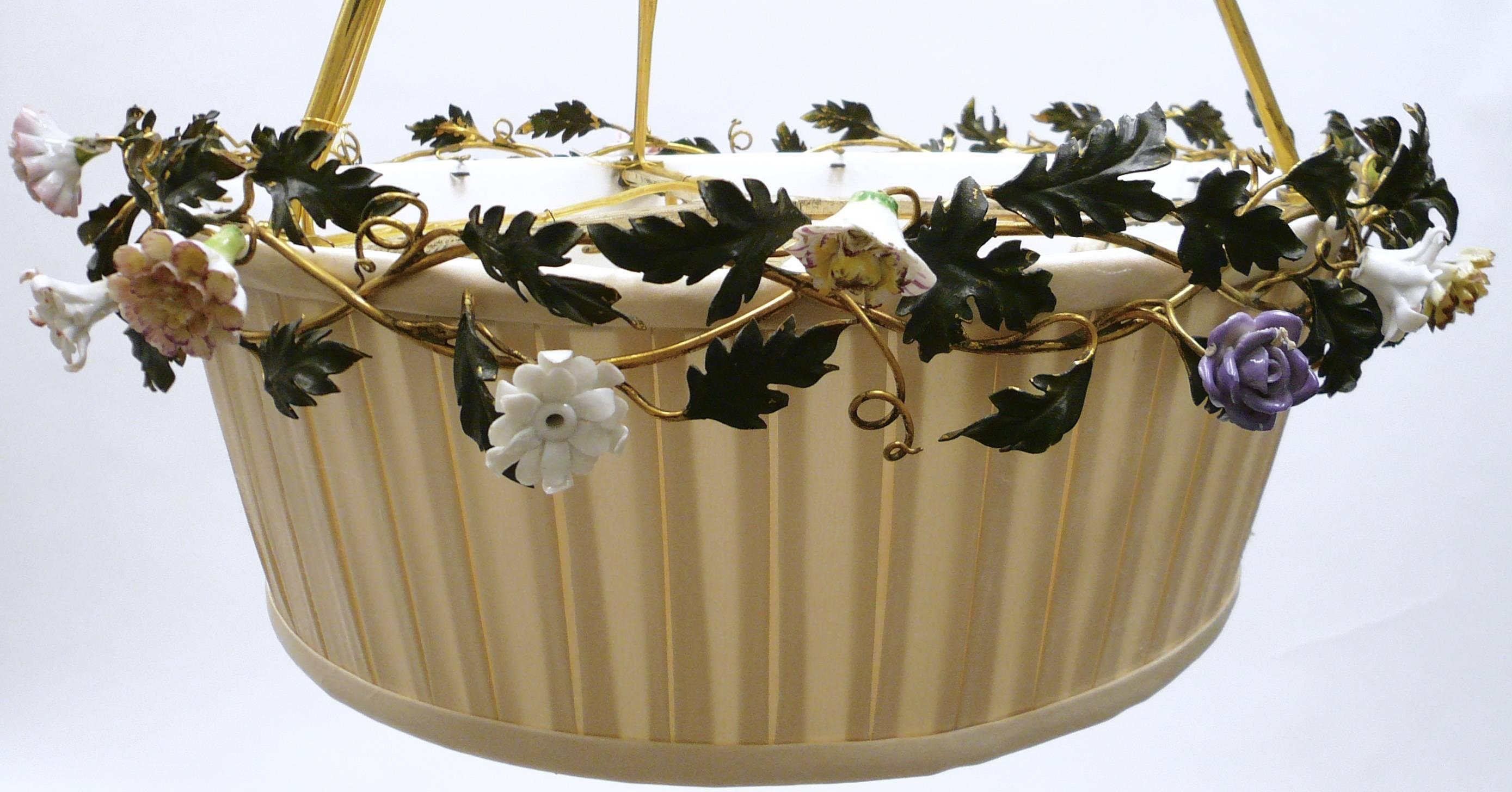 This charming Caldwell floral motif fixture features hand-painted porcelain flowers with gilt ribbons and bow knots. The original shade frame has been newly recovered in ivory silk.