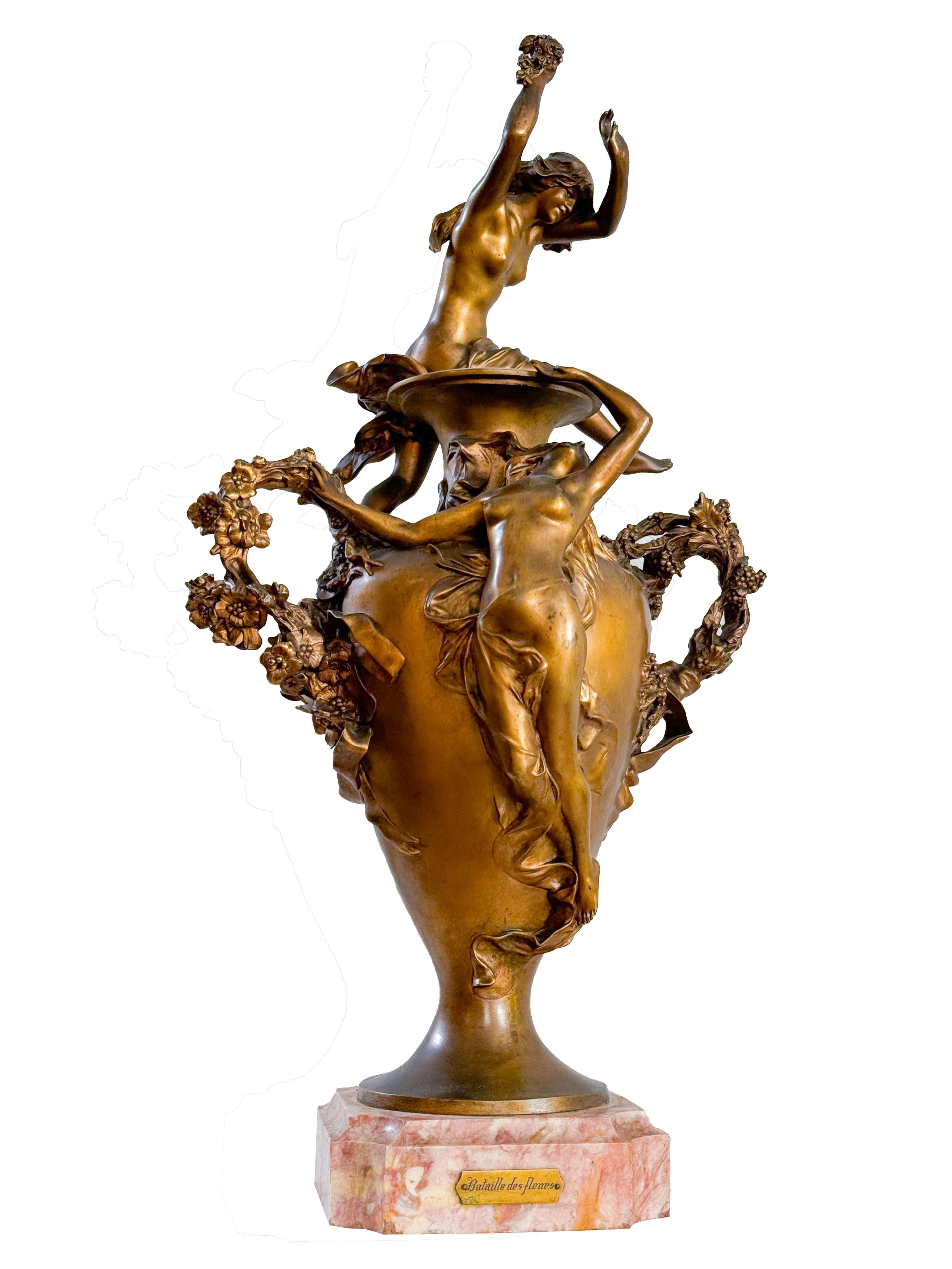 Félix Charpentier's masterpiece, 'Bataille des fleurs,' is a stunning golden bronze statue with a beautiful gilded patina finish. 

It draws inspiration from the colorful Carnival festivities of Côte d'Azur and portrays two nude nymphs and putto who