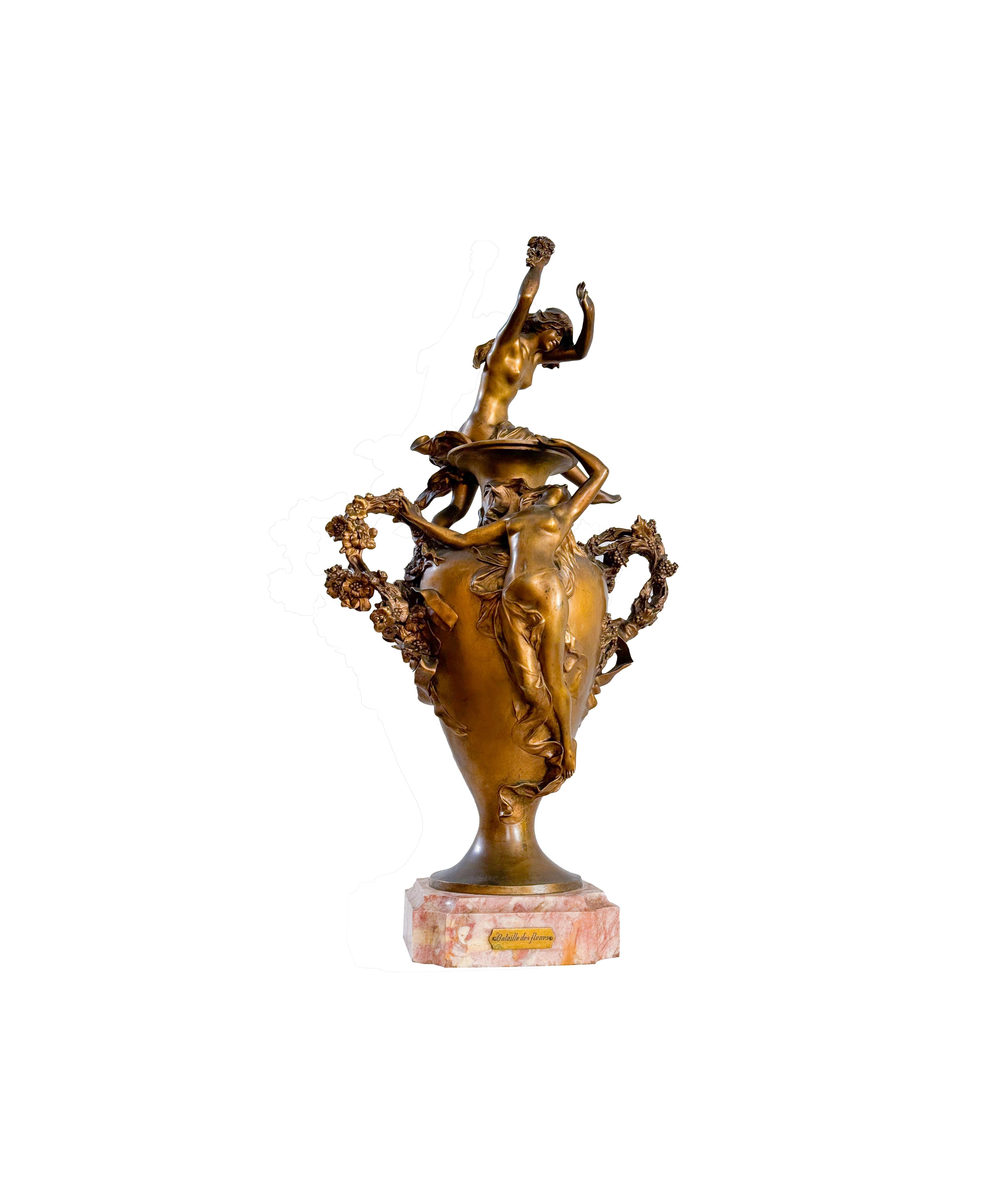 Félix Charpentier's masterpiece, 'Bataille des fleurs,' is a stunning golden bronze statue with a beautiful gilded patina finish. 

It draws inspiration from the colorful Carnival festivities of Côte d'Azur and portrays two nude nymphs and putto who