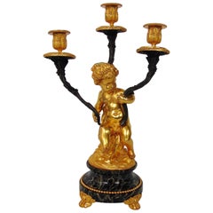 Gilt Bronze Candlestick Cast in the Form of a Ormolu Cherub