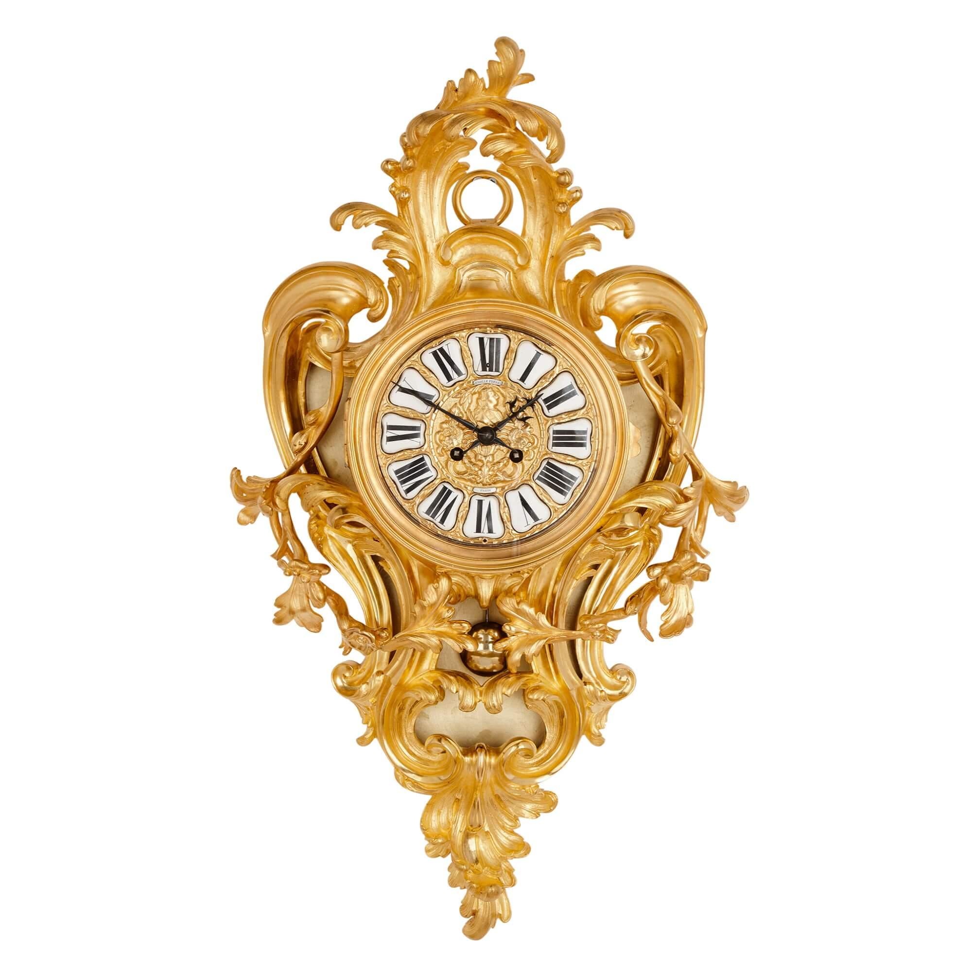 Gilt-bronze cartel clock and Barometer set by Lerolle Frères
French, c. 1860
Measures: Barometer: height 71cm, width 43cm, depth 15cm
Clock: height 71cm, width 40cm, depth 15cm

Each with floral decoration and enamel cartouches that are signed,