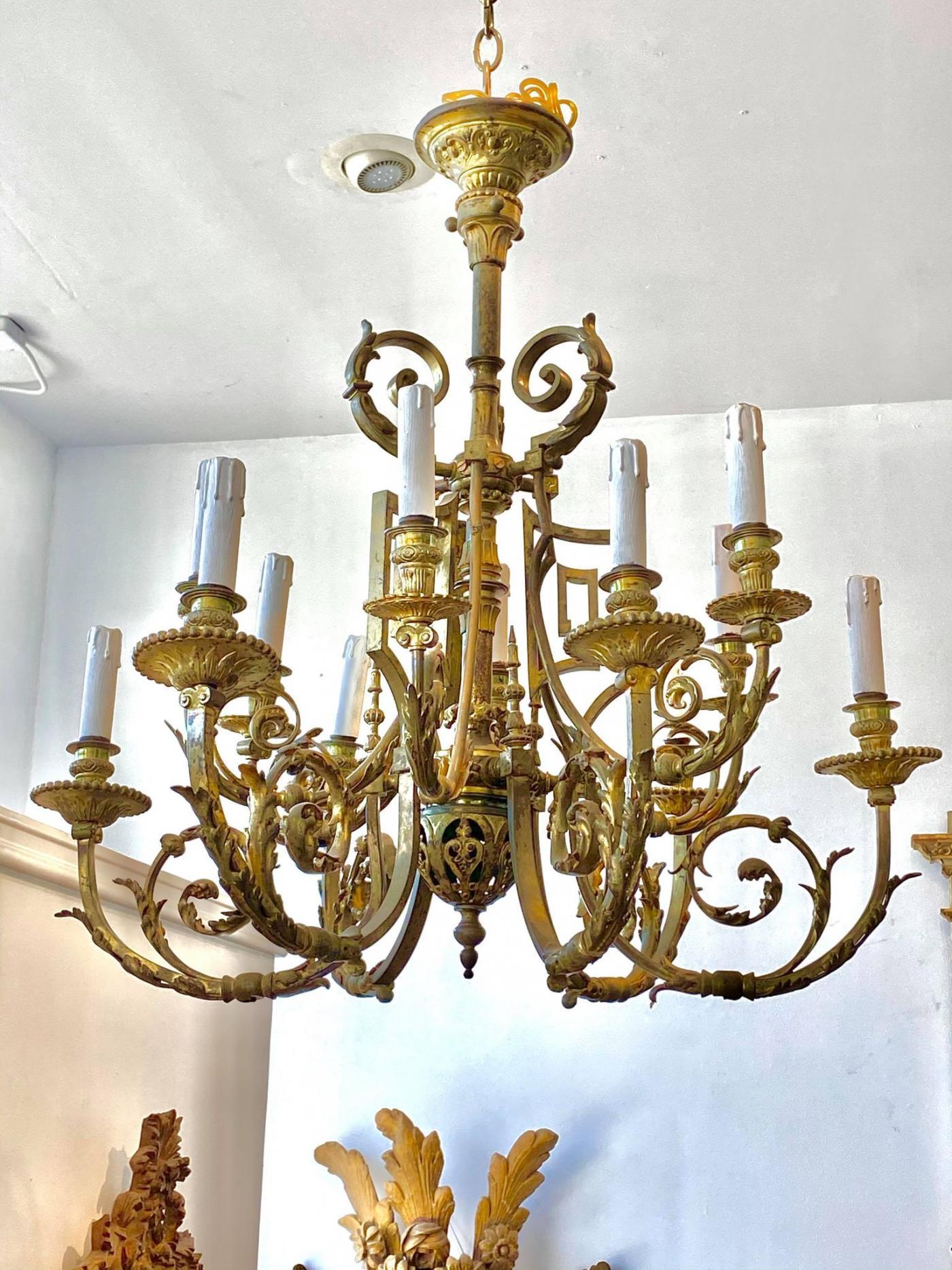 Vasiform fluted standard issuing leaf and bellflower cast arms with fluted nozzles above a pierced scrolling corona.