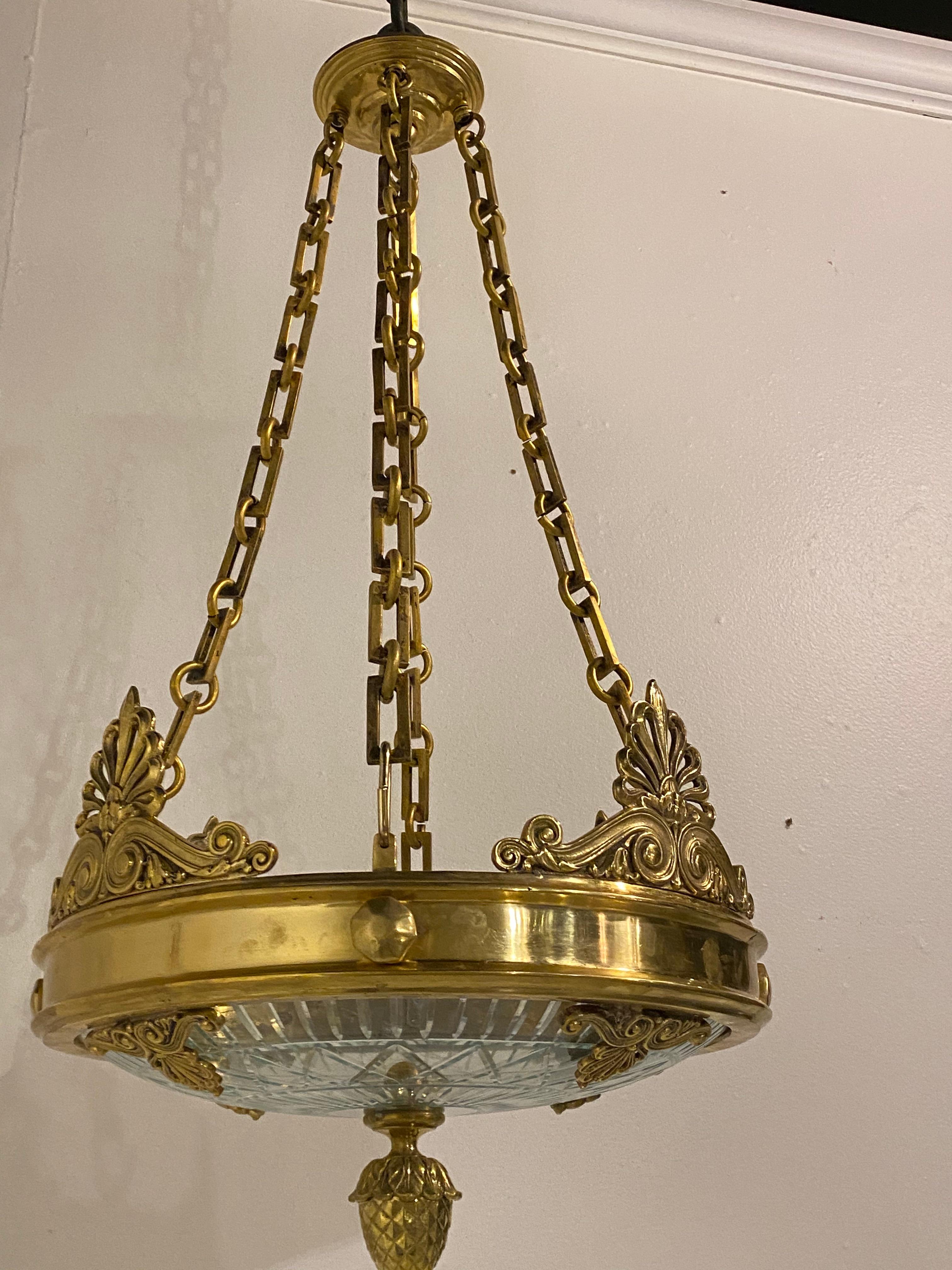 A circa 1900 gilt bronze chandelier with cut glass inset. In very good vintage condition. 

Dealer: G302YP 


