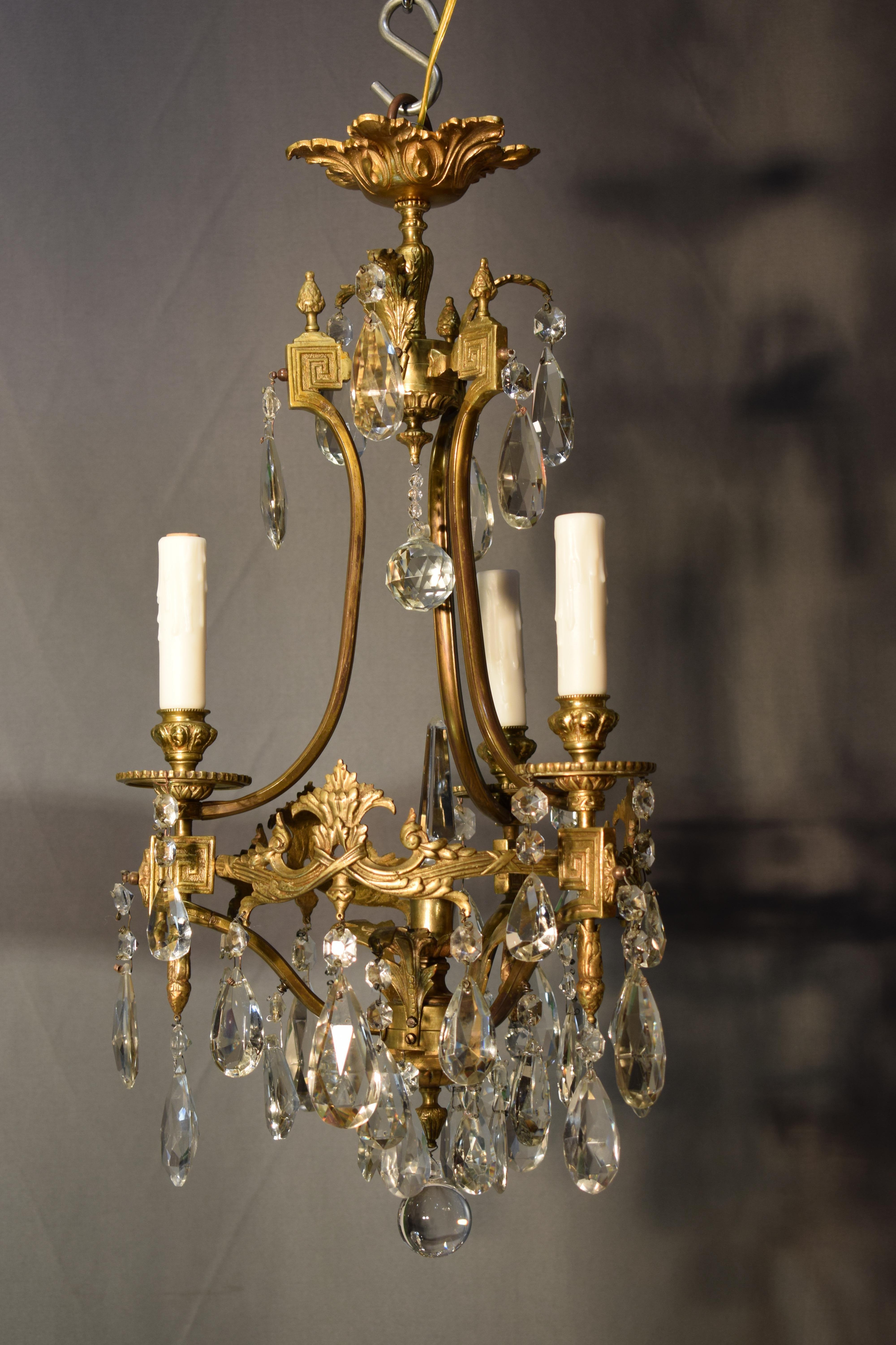 A fine gilt bronze and crystal chandelier by Baccarat. In Good Condition In Atlanta, GA
