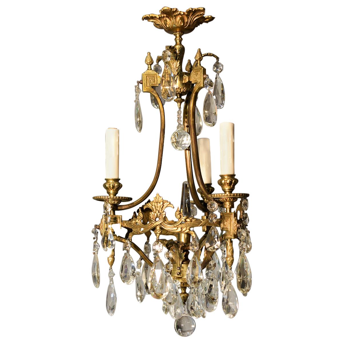 A fine gilt bronze and crystal chandelier by Baccarat.
France, circa 1920. 3-light
Dimensions: Height 26 1/2