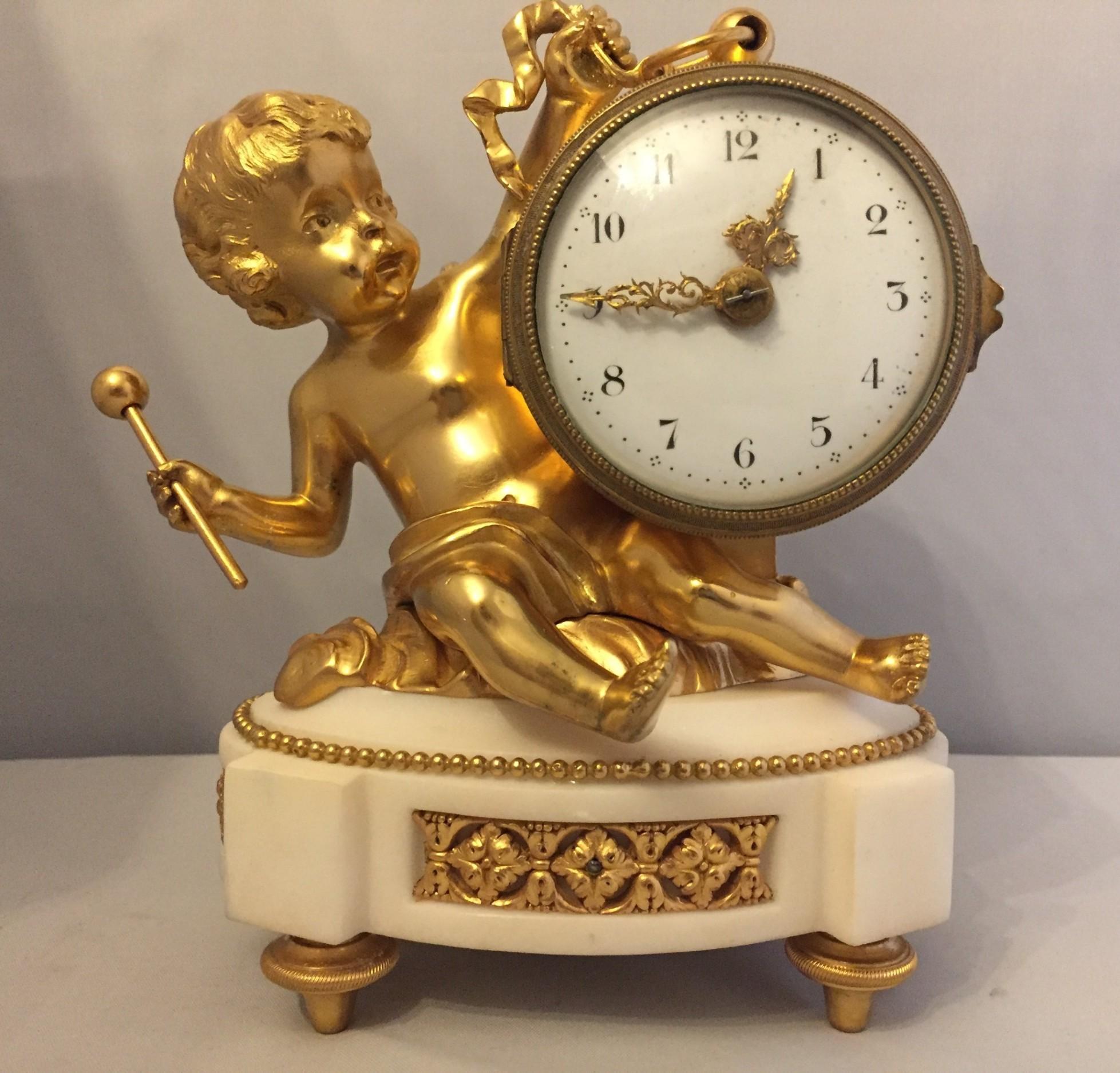 French 19th century Ormolu And White Marble Cherub Clock.
A superb small ormolu and white marble 8 day French timepiece with white prcelain dial, arabic numerals, with putto holding hammer to strike drum casing housing the movement. 12 month