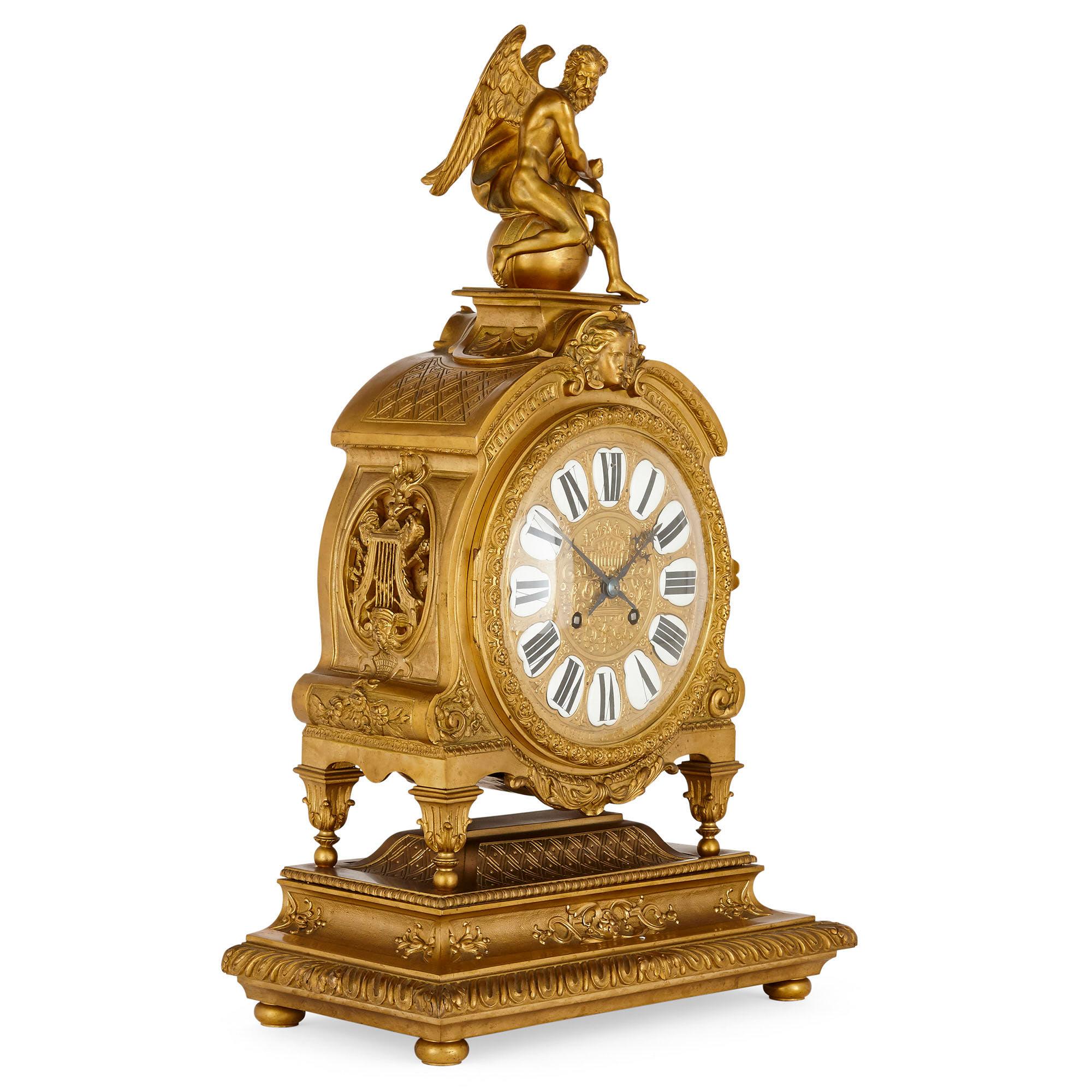 Gilt-bronze clock with enamel numerals attributed to Henri Picard
French, circa 1860
Measures: Height 73cm, width 45cm, depth 23cm

The elaborate case of this beautiful mantel clock has a large central circular dial with enamel Roman numerals