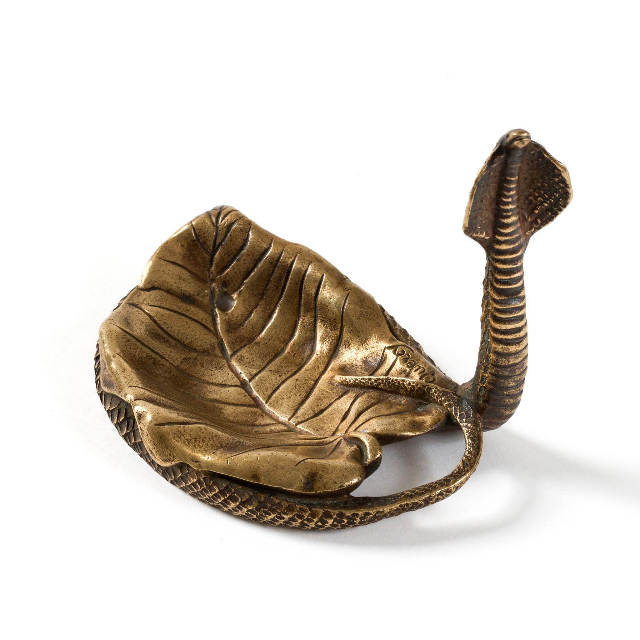 This three piece set made of gilt bronze from the Art Nouveau period is cast in the alluring forms of cobras, frozen in the midst of their mesmerizing dances. Comprised of a glass-lined inkwell, a letter opener, and a pen tray, the desk set features