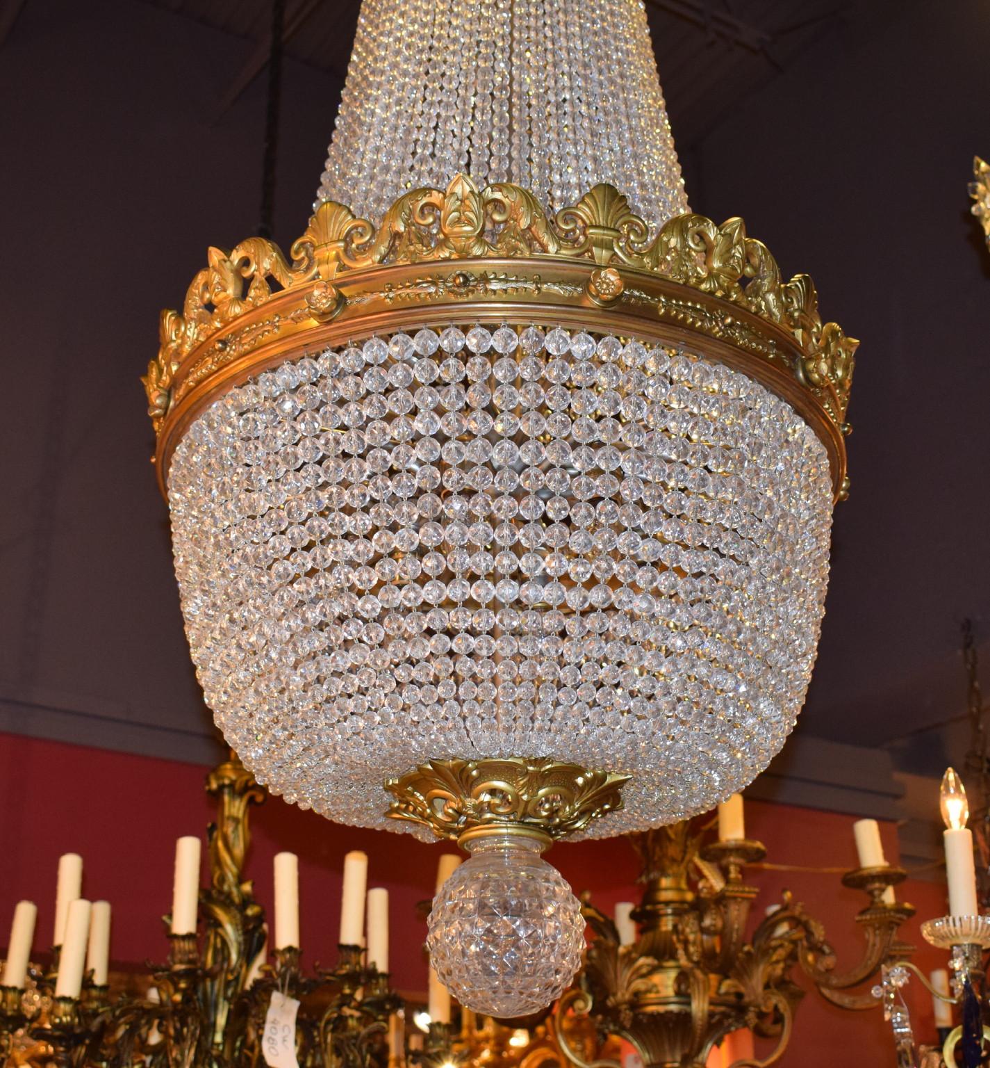 A very fine gilt bronze and crystal basket chandelier attributed to Baccarat. 15-light
France, circa 1910.
Dimensions: Height 54