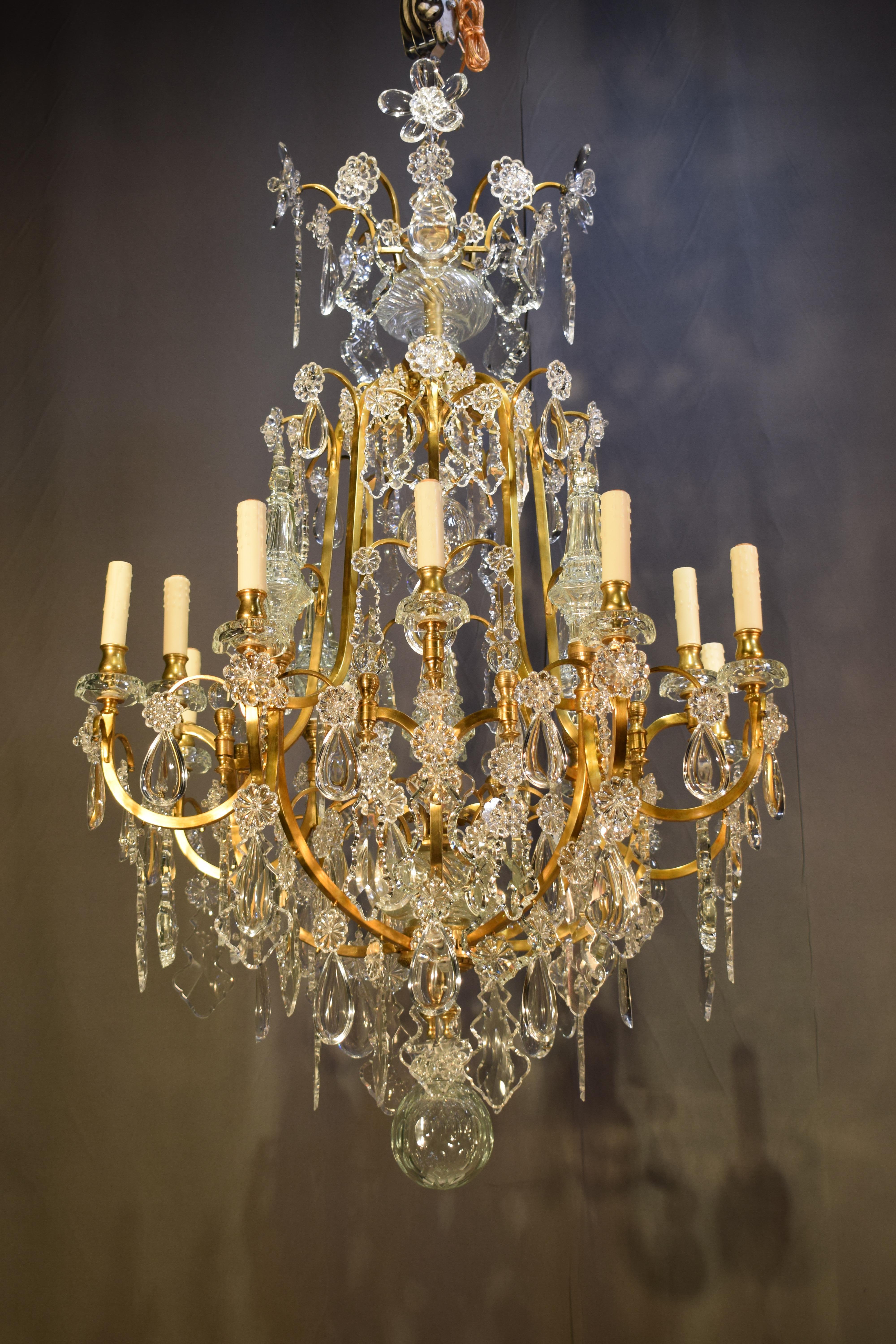 A very fine gilt bronze and crystal chandelier. In the Louis XV style. By Baccarat, circa 1910. 12 Lights.
Dimensions: Height 53