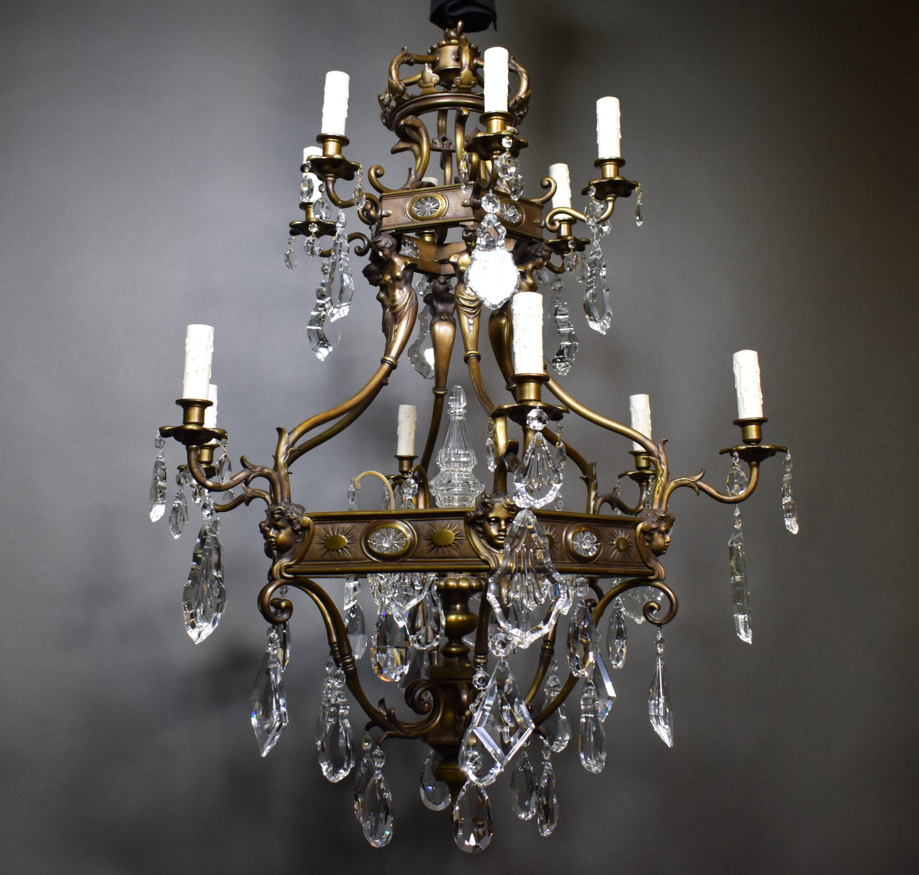 A very fine and important bronze chandelier featuring hand cut crystal pendalogues and central pyramid.
France, circa 1910. 12 lights.
Dimensions: Height 53