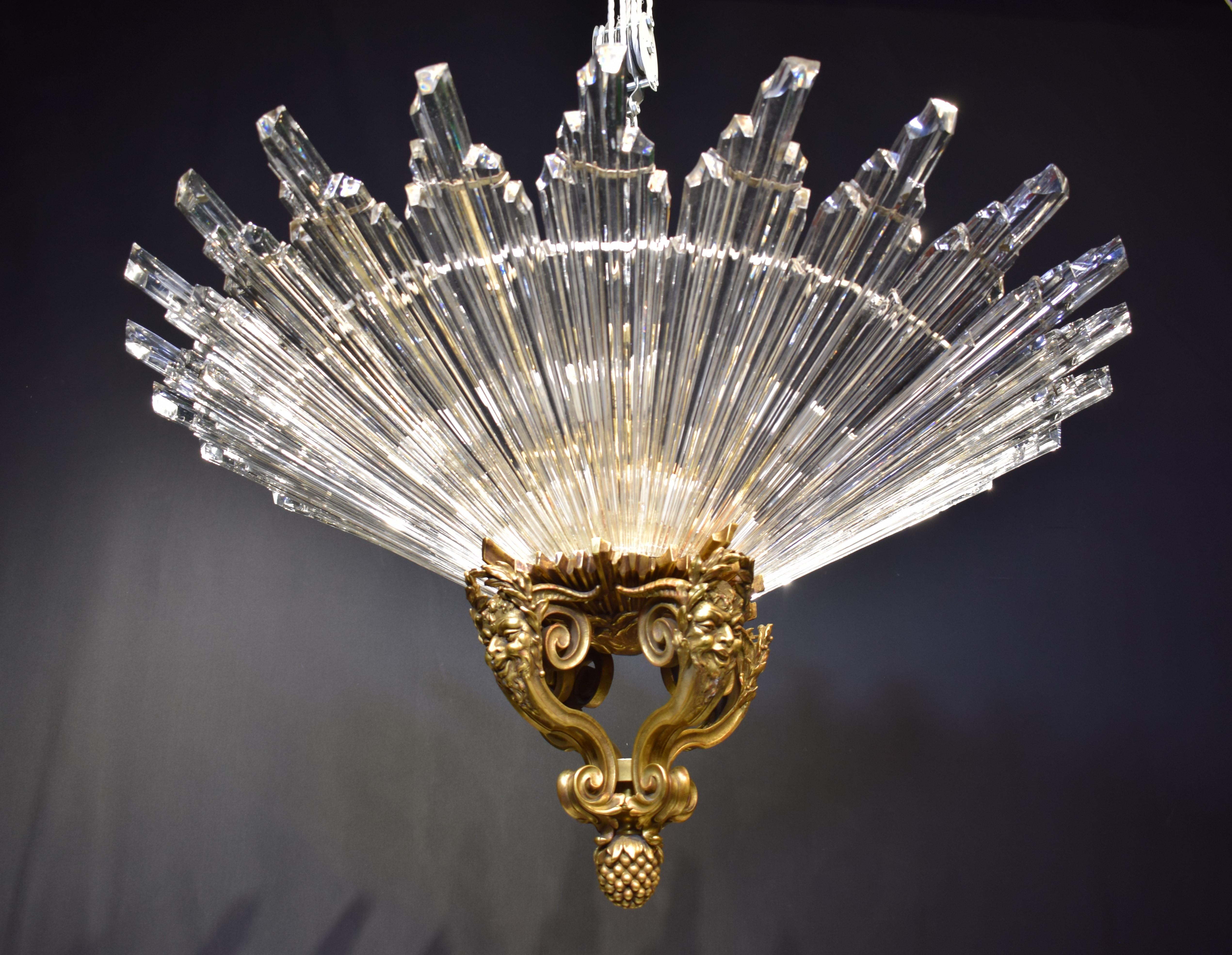 A Magnificent Gilt Bronze & Crystal Chandelier featuring crystal rays at the bottom, gilt bronze ornament depicting male faces. France, circa 1900.
Dimensions: Height 20