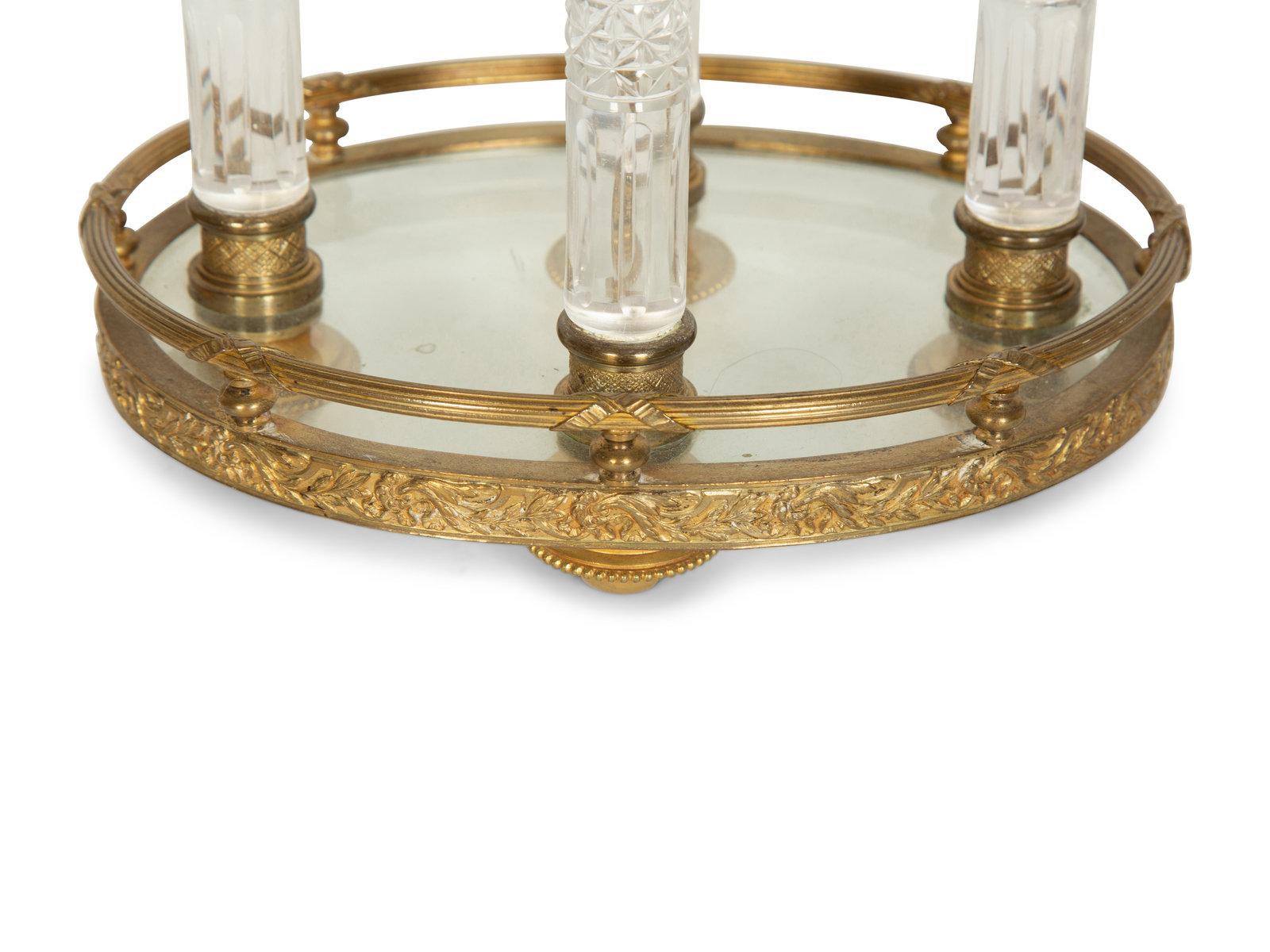 A very fine gilt bronze centerpiece featuring hand cut crystal columns (4). Base and Top supporting oval container. France, circa 1900. 
Dimensions: Height 10 1/2