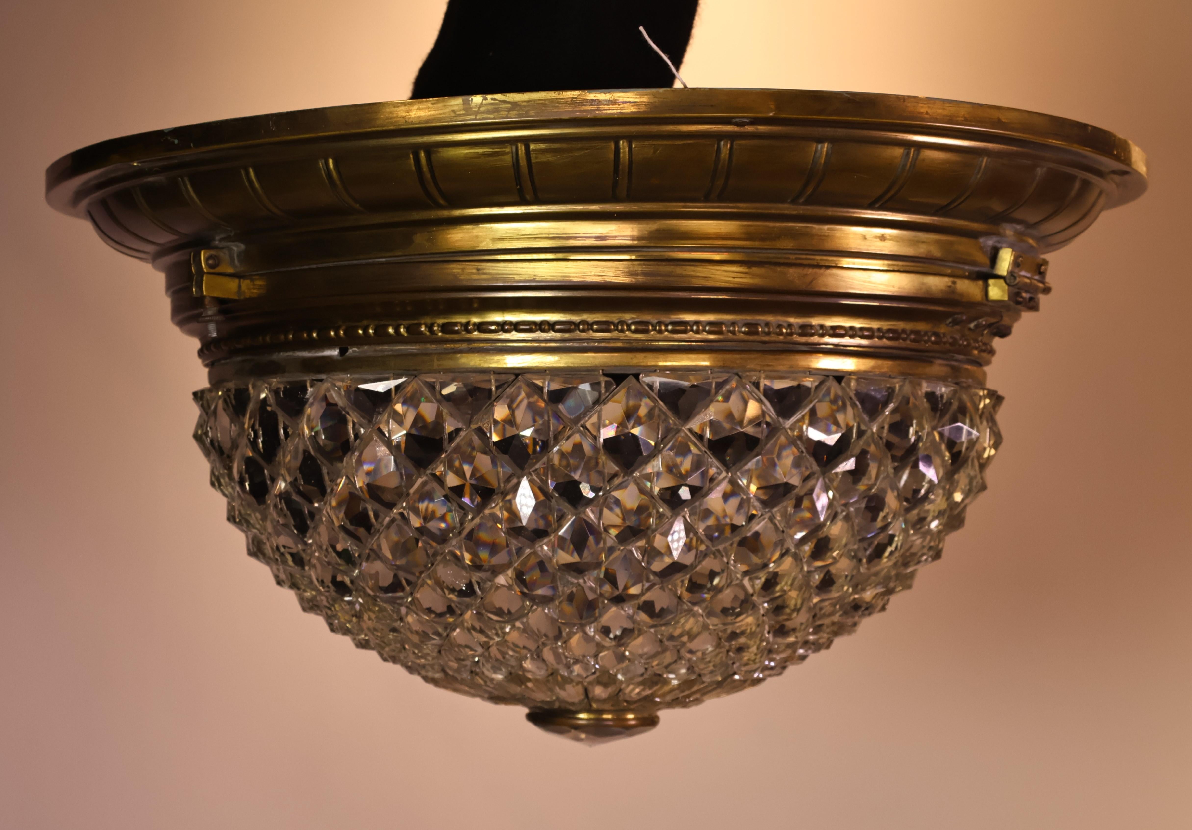 A Very Fine Gilt Bronze & Crystal Pendant/Plafonnier featuring hand cut crystal dome centered in the bottom by a hand cut round oculus. 
2 lights. France, circa 1900.
Dimensions: Height 11  Diameter  20