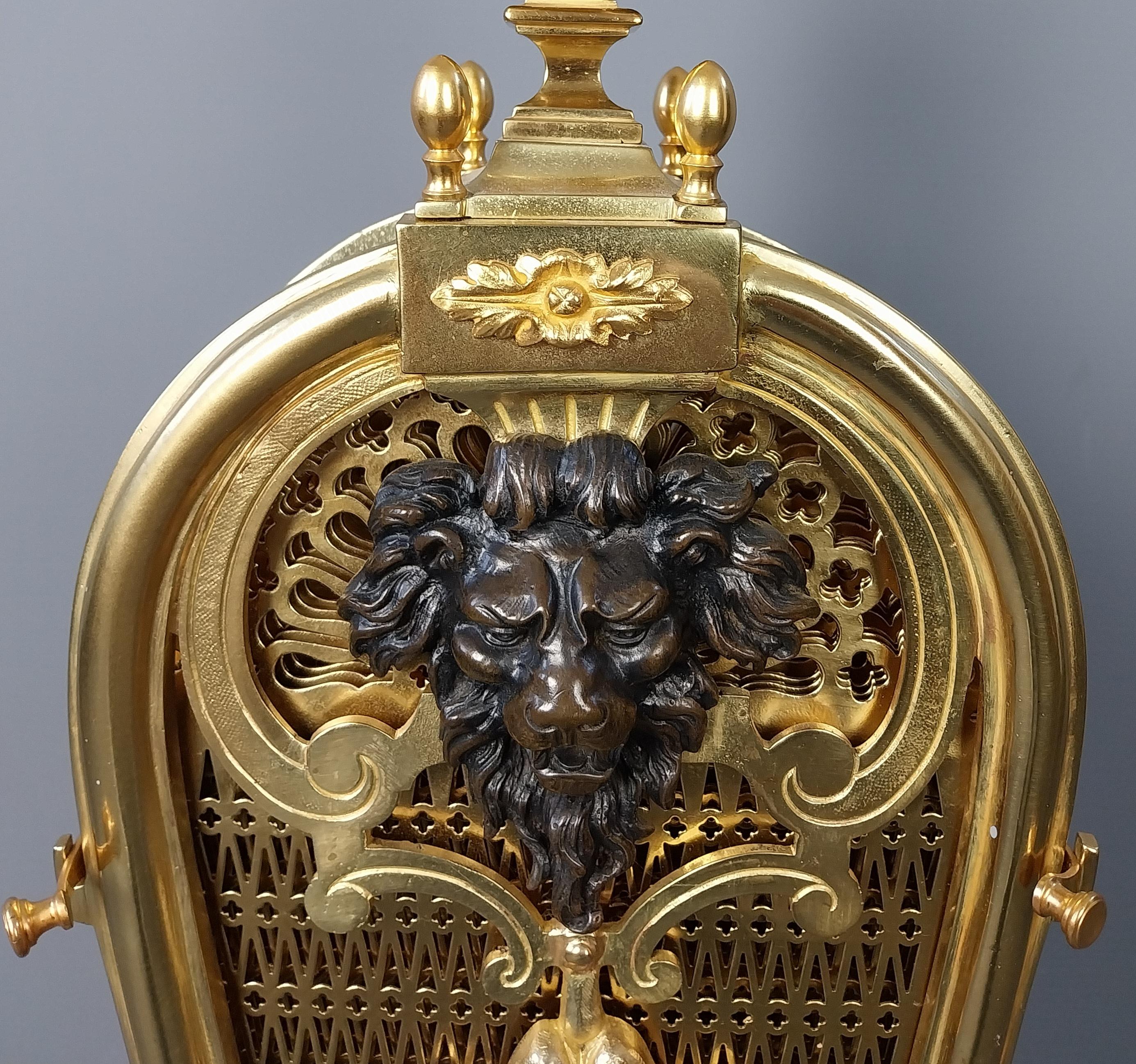Gilt Bronze Antique Fire Screen made by Bouhon, this is a magnificent Peacock style Fire Screen having wonderful Bronze Lions head cast to the front, the centre section un locks to release eight radiating pierced fan acting as a most decorative