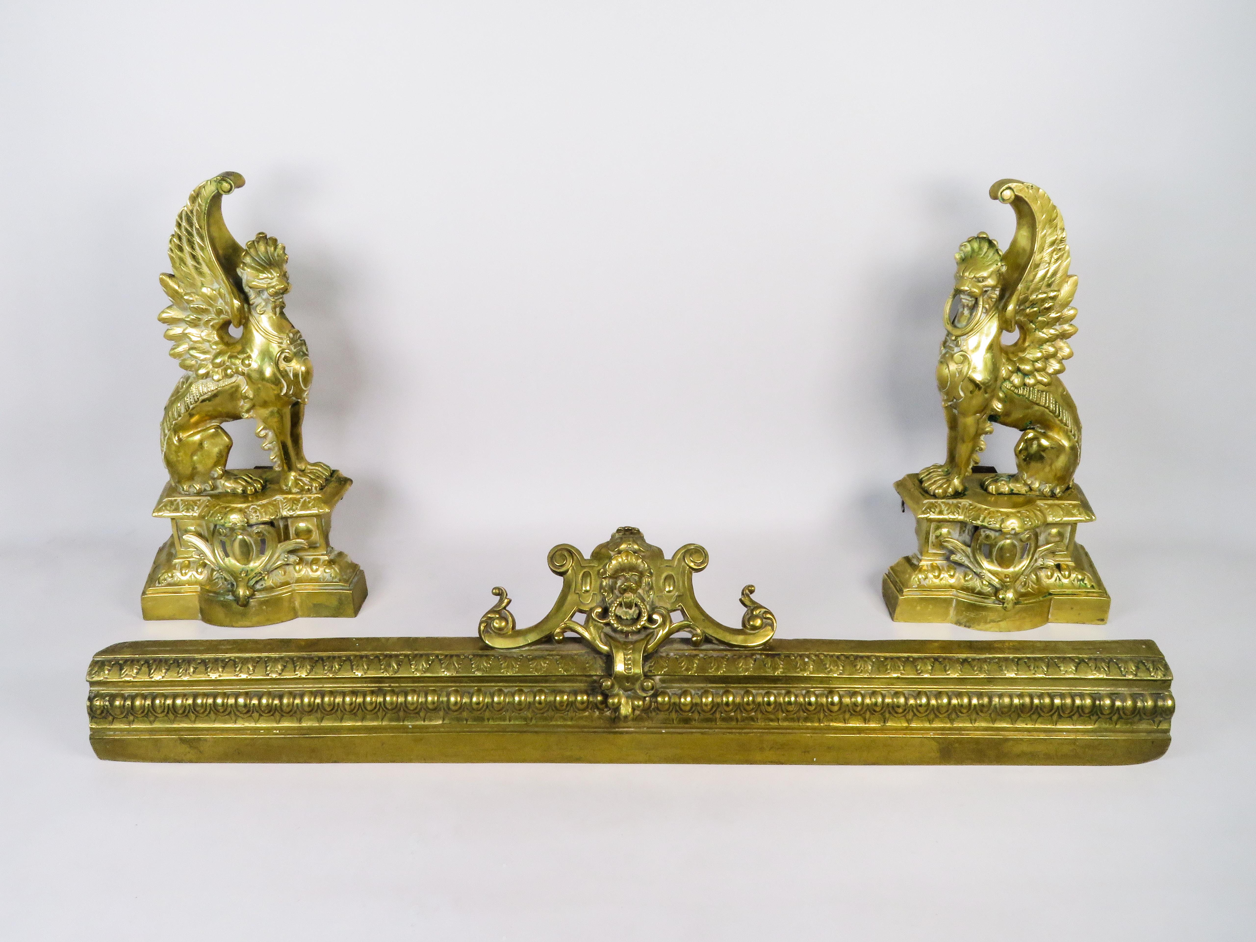 Gilt bronze fireplace andirons - Neoclassical style - France - late 19th century.

Composed of three cast pieces: an elongated central base with a masked relief decoration, flanked by figures of winged griffins seated on a pedestal.

Measurements:
*