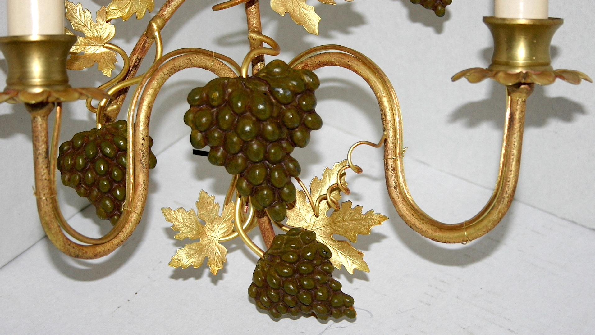 Pair of 1920s gilt bronze Italian sconces depicting grapevines with cluster of grapes.

Measurements: 
Height 14.5 in.
Depth 4.5 in.
Width/length: 10 in.

