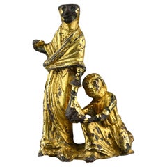 Vergoldete Bronzegruppe, die einen Akt des Almosengebens darstellt. England, Anfang des 12. Jahrhunderts