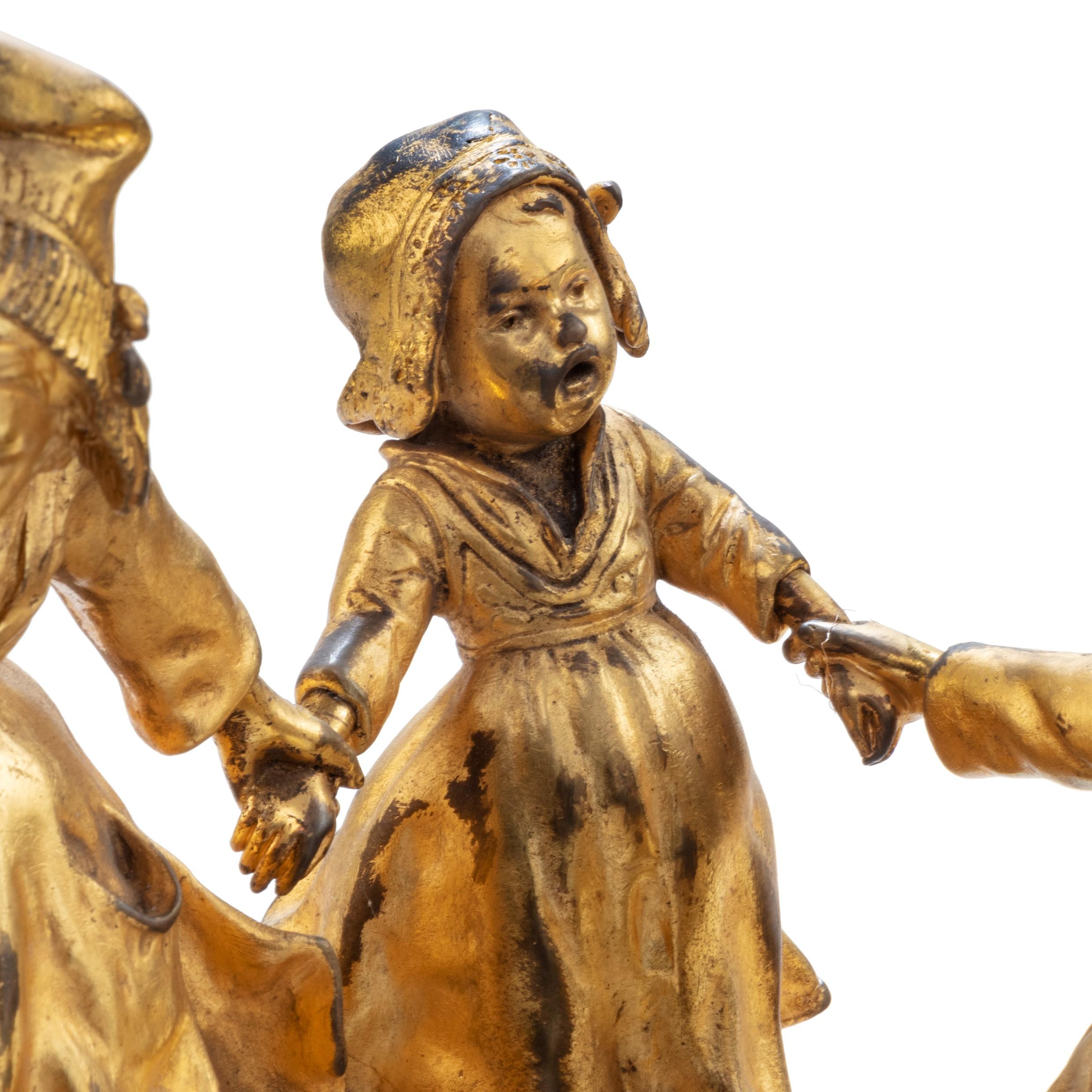 A charming gilt bronze group of Dutch children by D’Aste, showing five children in Dutch dress sliding on snow in their clogs, signed by J.D’ASTE.

Signed/Inscribed: signed by J.D’ASTE.

Guiseppe D’Aste was born in Naples but spent much of his