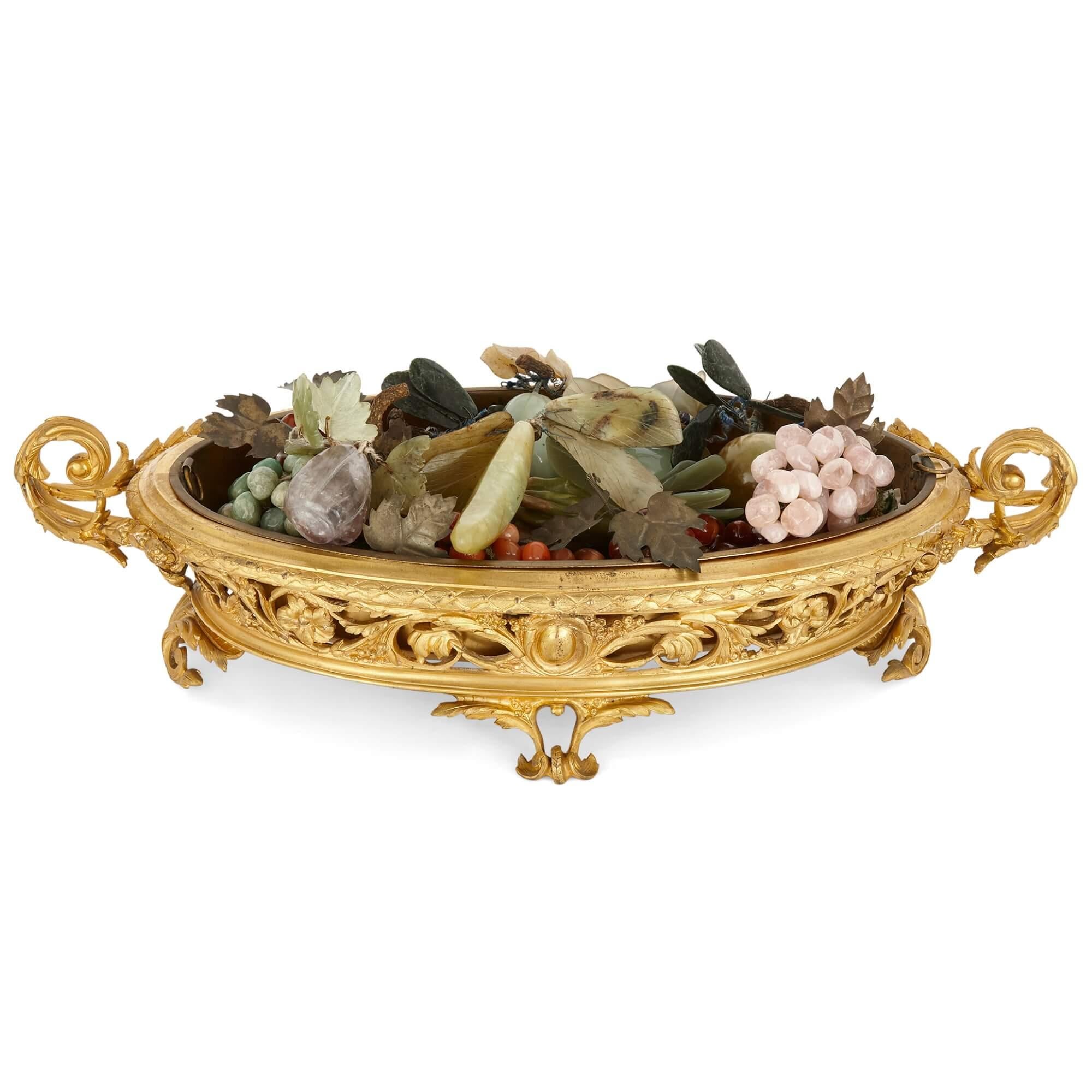 Gilt bronze jardinière with hardstone fruits
French, Early 20th Century 
Height 15cm, width 57cm, depth 26cm

The jardinière is wonderfully cast from gilt bronze and filled with a selection of polychrome hardstone fruits. 

The body of the