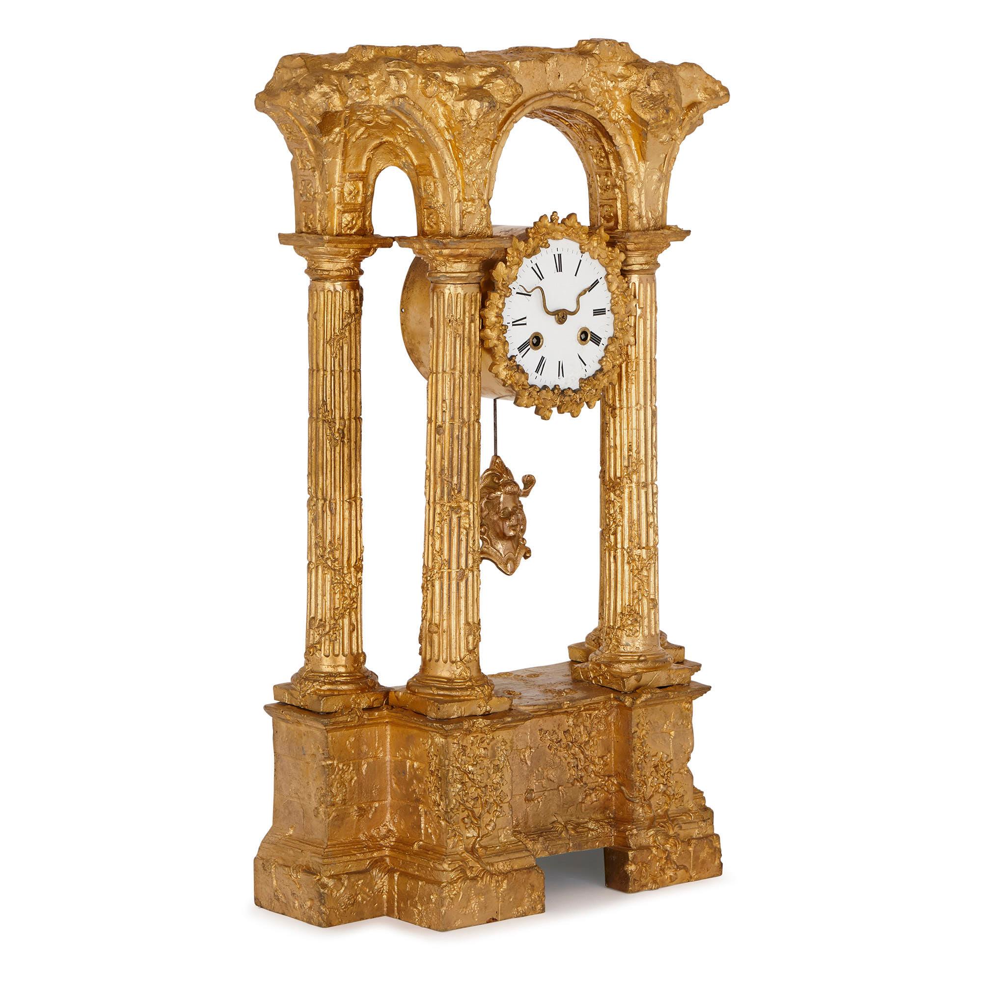 This wonderful mantel clock is designed in the image of an ancient Roman ruin. The clock is clearly inspired by the kind of prints, paintings and drawings of dilapidated Roman buildings, which were brought back from Italy by Grand Tourists in the
