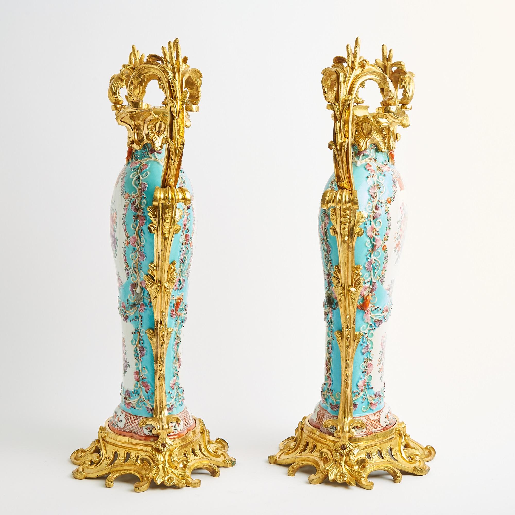 A magnificent pair of gilt bronze-mounted English Samson porcelain decorative urns, showcasing exceptional craftsmanship and timeless elegance. Each urn features a flattened baluster form, adorned with hand-painted floral and foliate reserves in